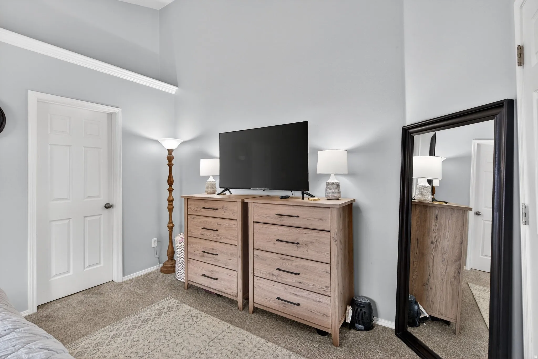 Bedroom with light carpet and baseboards