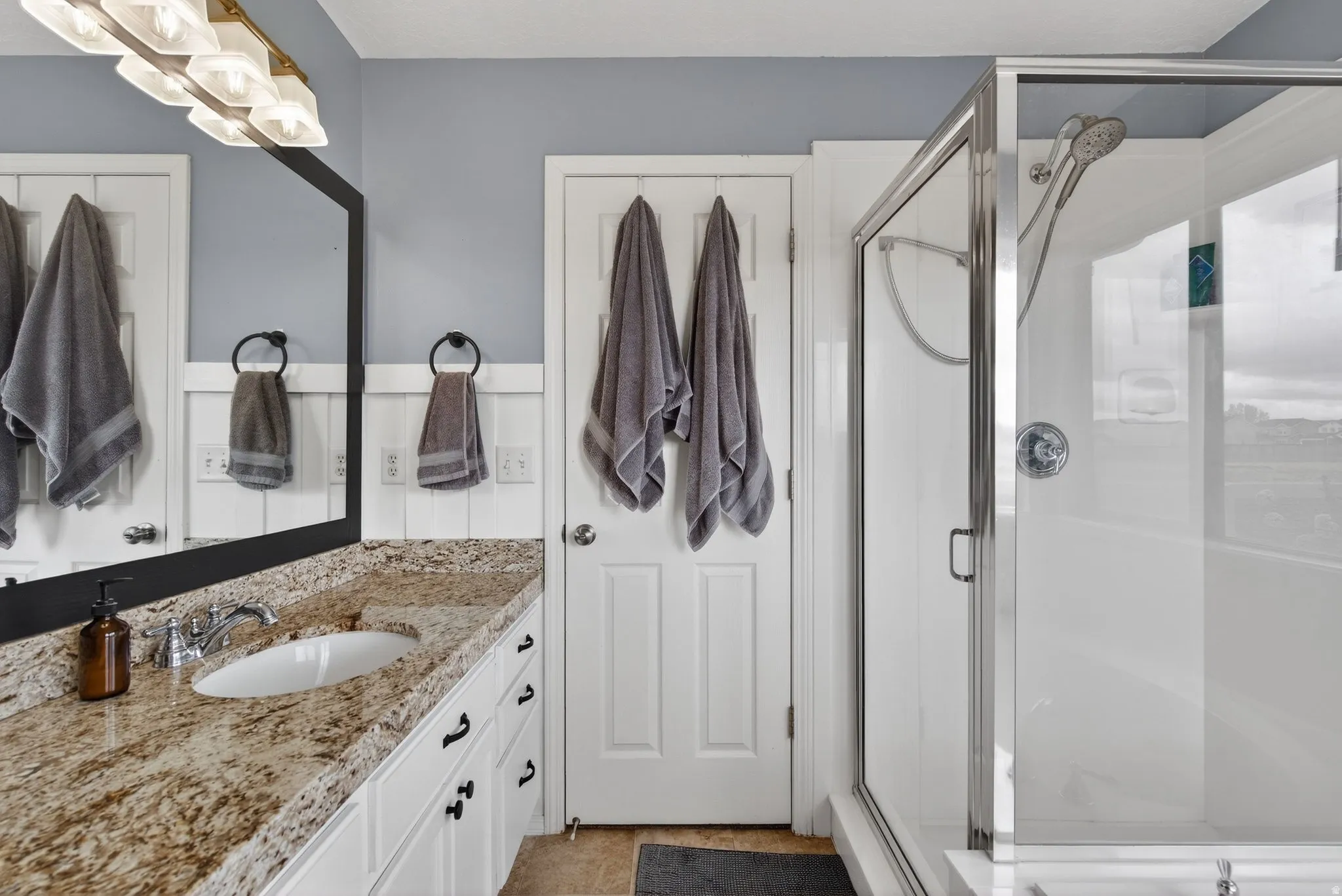 Bathroom featuring vanity and a stall shower