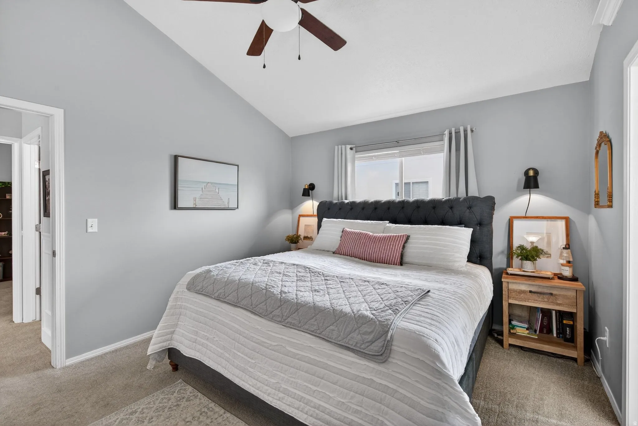 Carpeted bedroom with lofted ceiling and ceiling fan