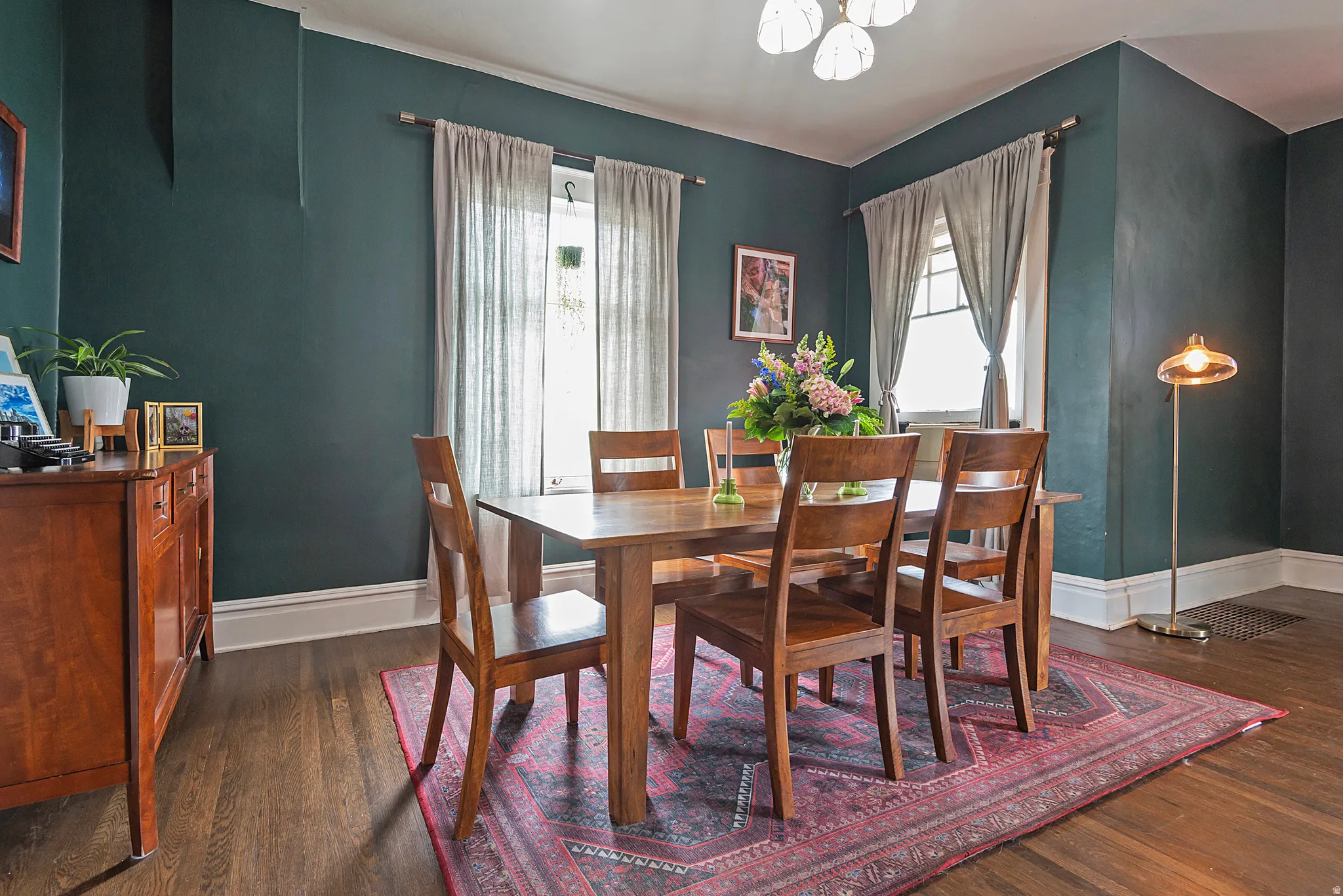 Dining space featuring dark wood-type flooring and healthy amount of natural light