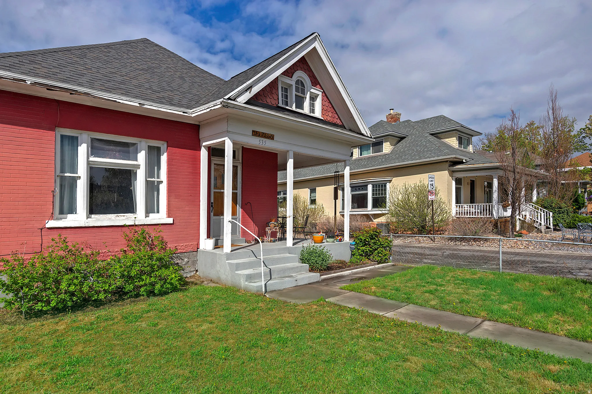 View of front of house with a front yard and a porch