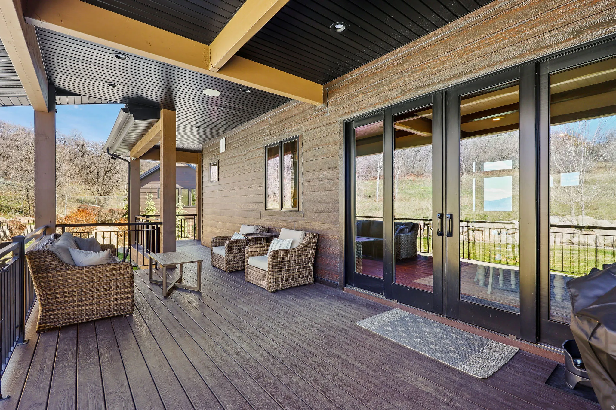 Wooden terrace featuring an outdoor living space and french doors