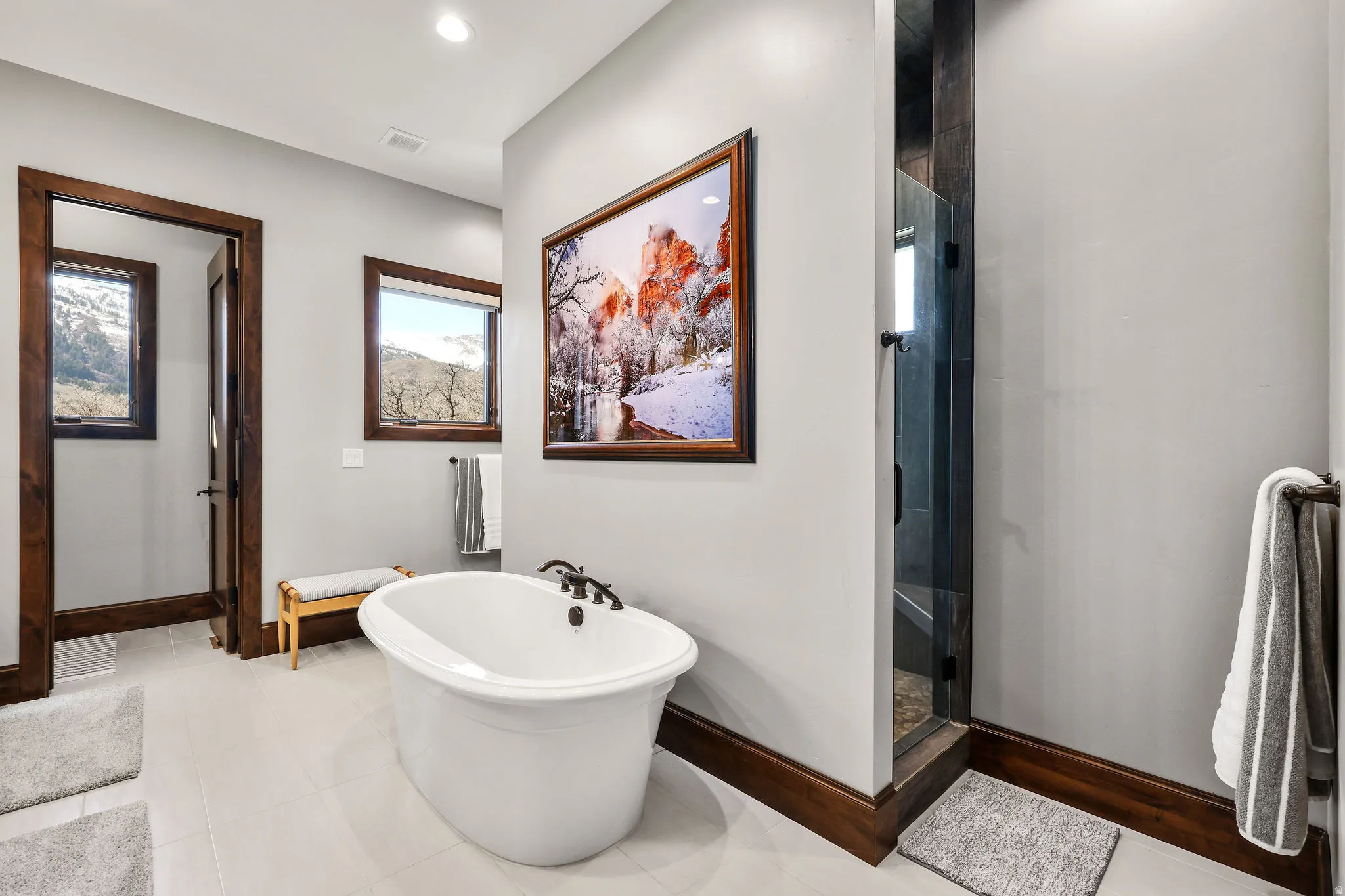 Full bath with a freestanding bath, a shower stall, light tile patterned floors, and recessed lighting