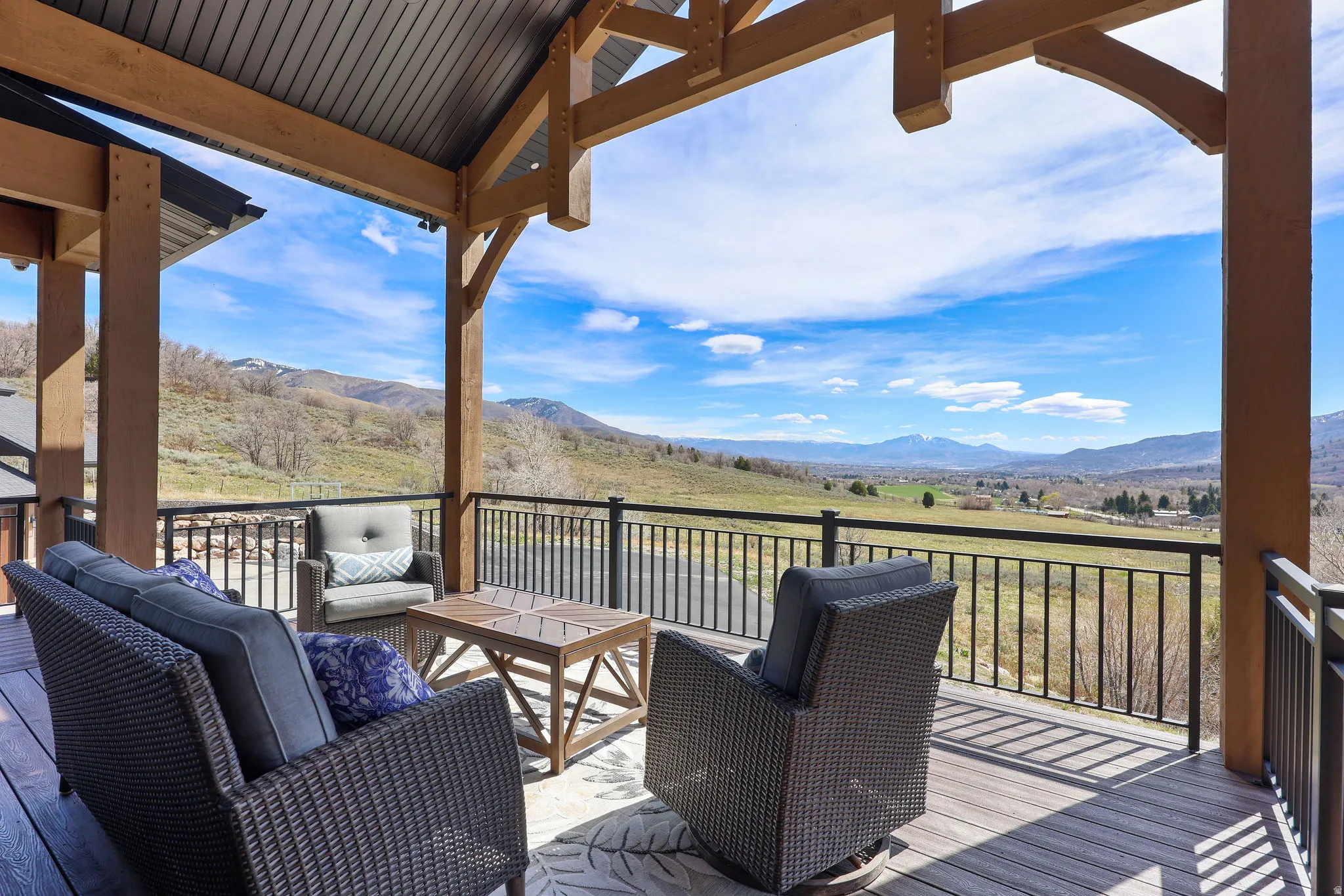 Wooden deck with an outdoor hangout area and a mountain view