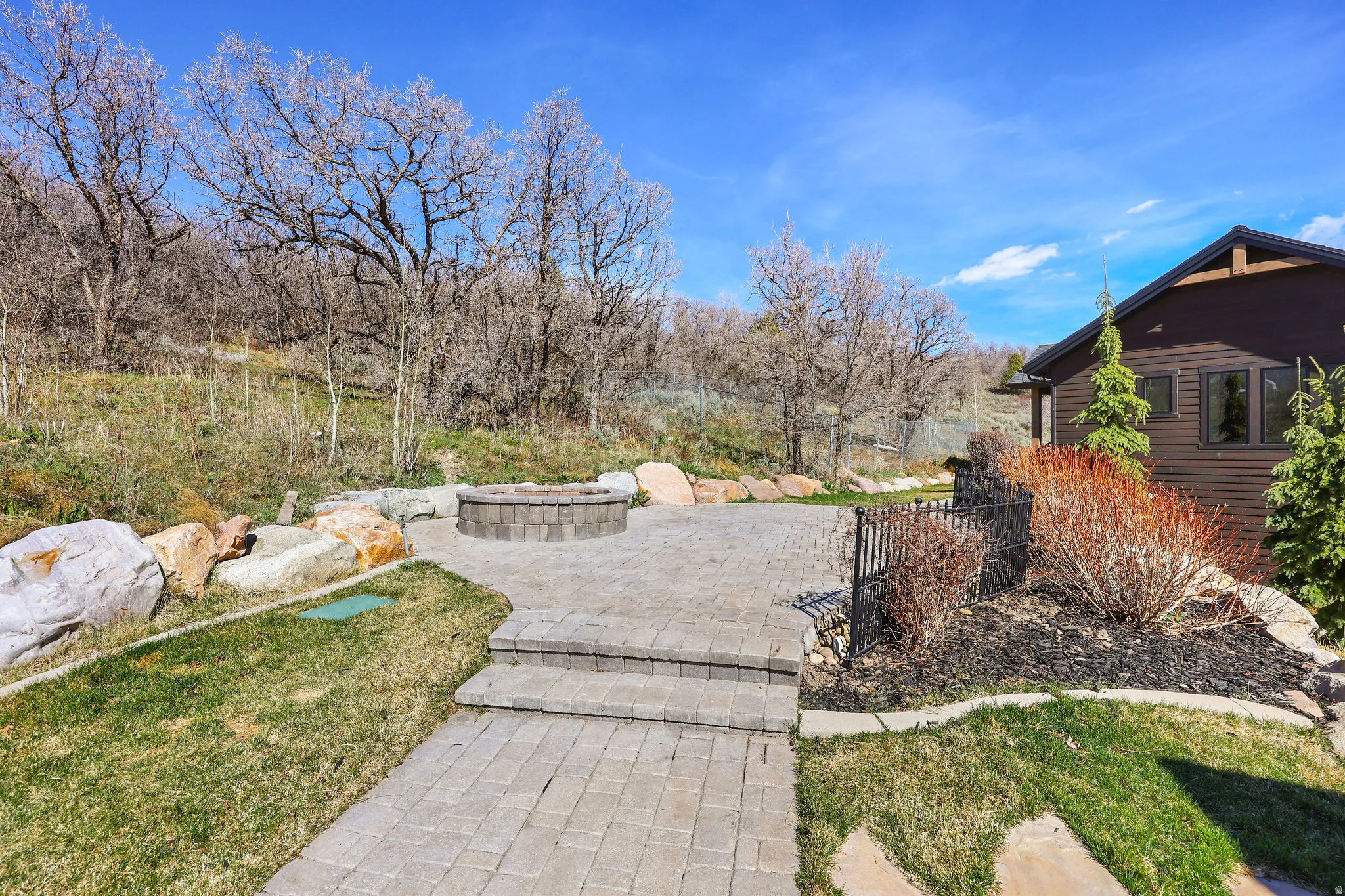 View of yard with an outdoor fire pit and a patio area