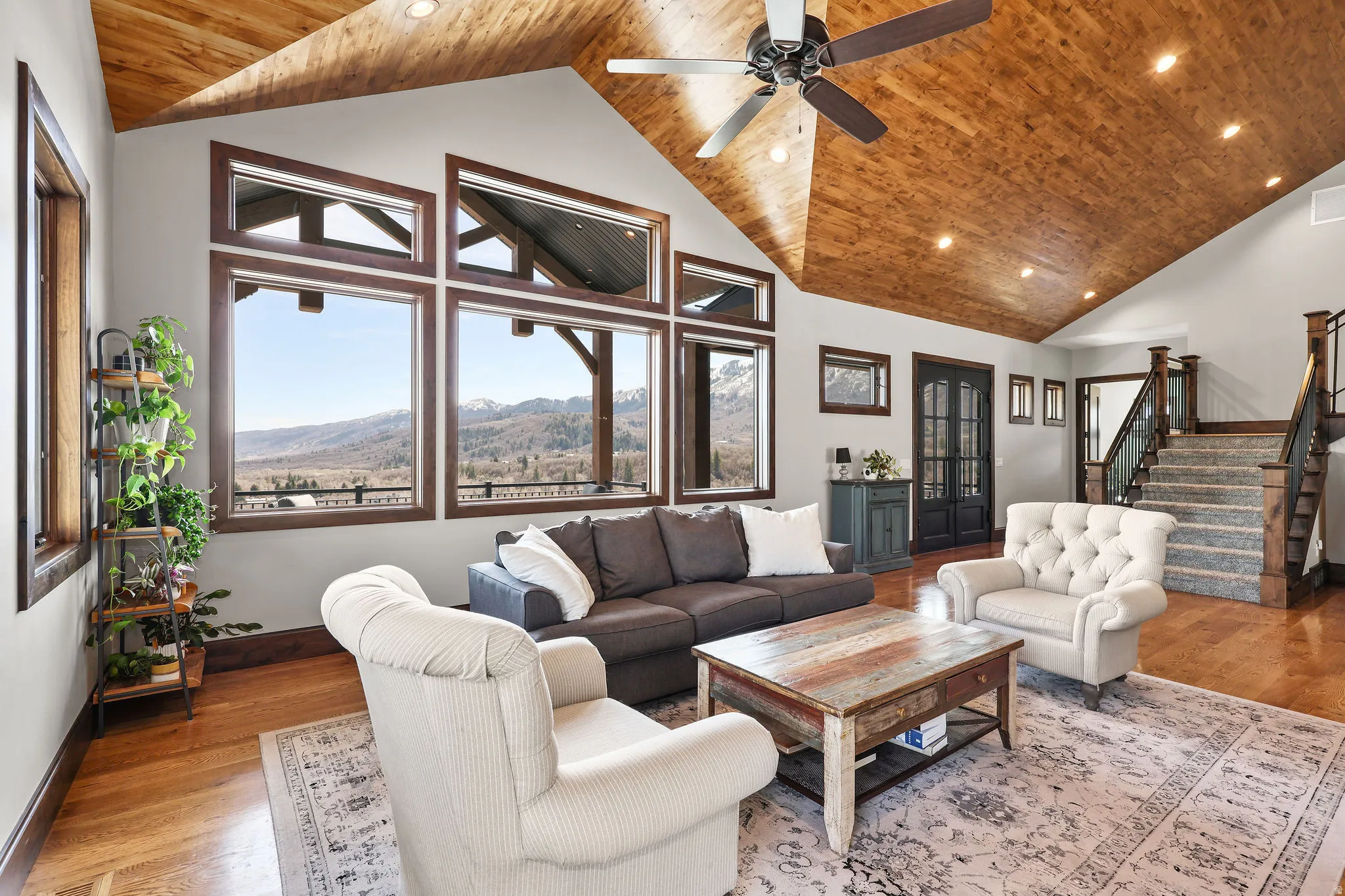 Living room with a high wooden ceiling, a mountain view, wood finished floors, recessed lighting, and ceiling fan