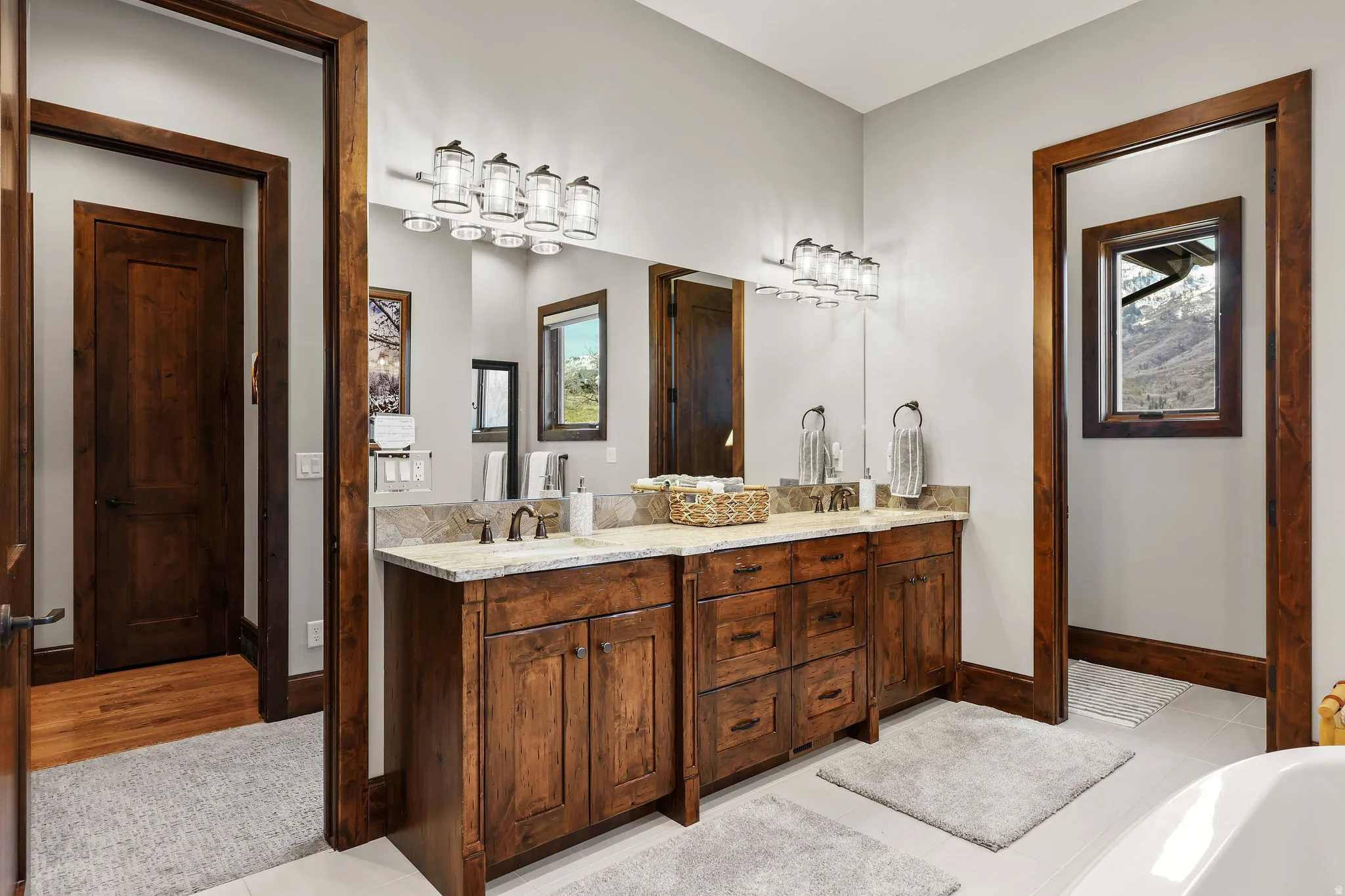 Full bathroom featuring double vanity and a tub