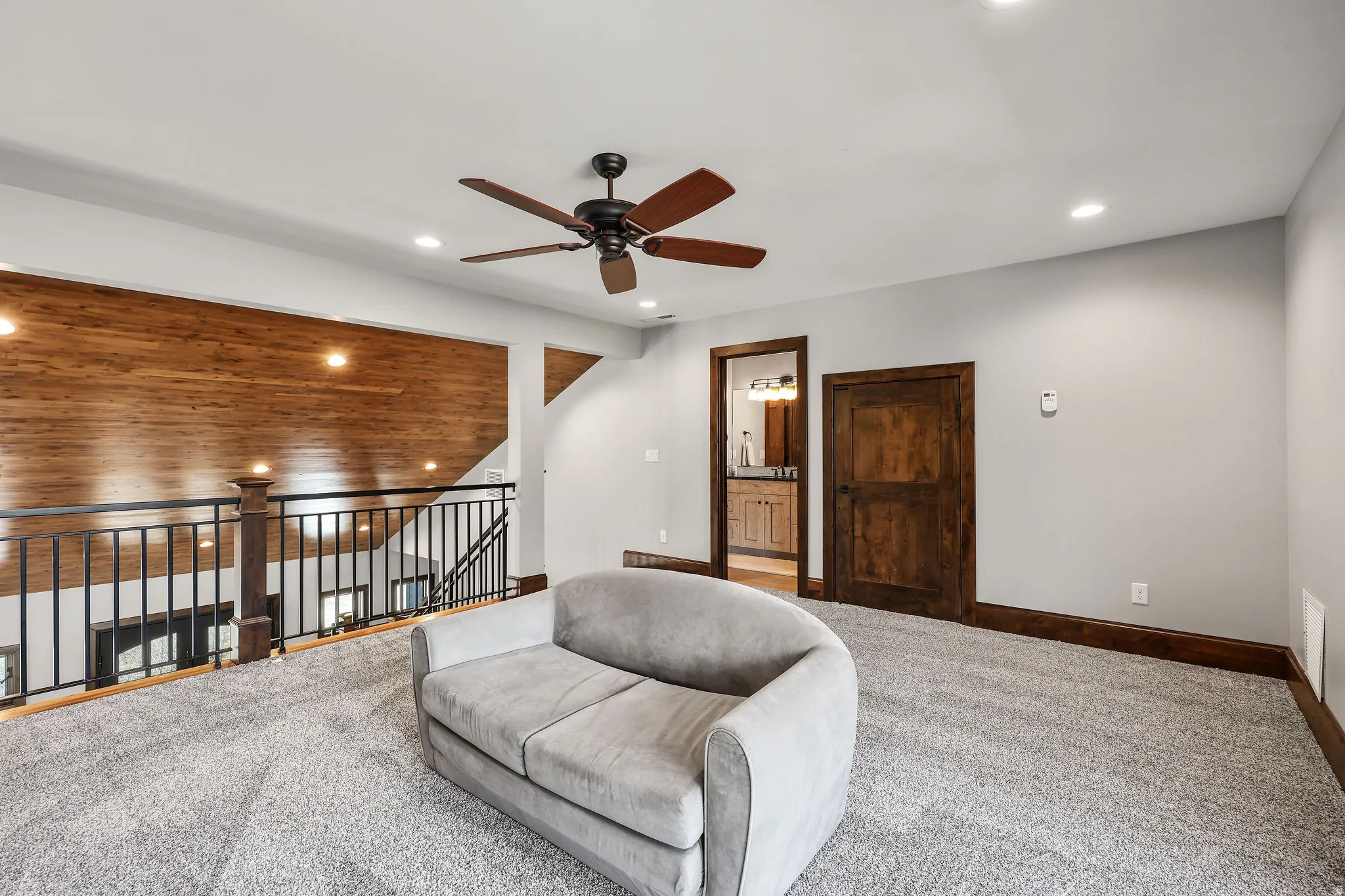 Living area featuring ceiling fan, carpet floors, recessed lighting, and lofted ceiling