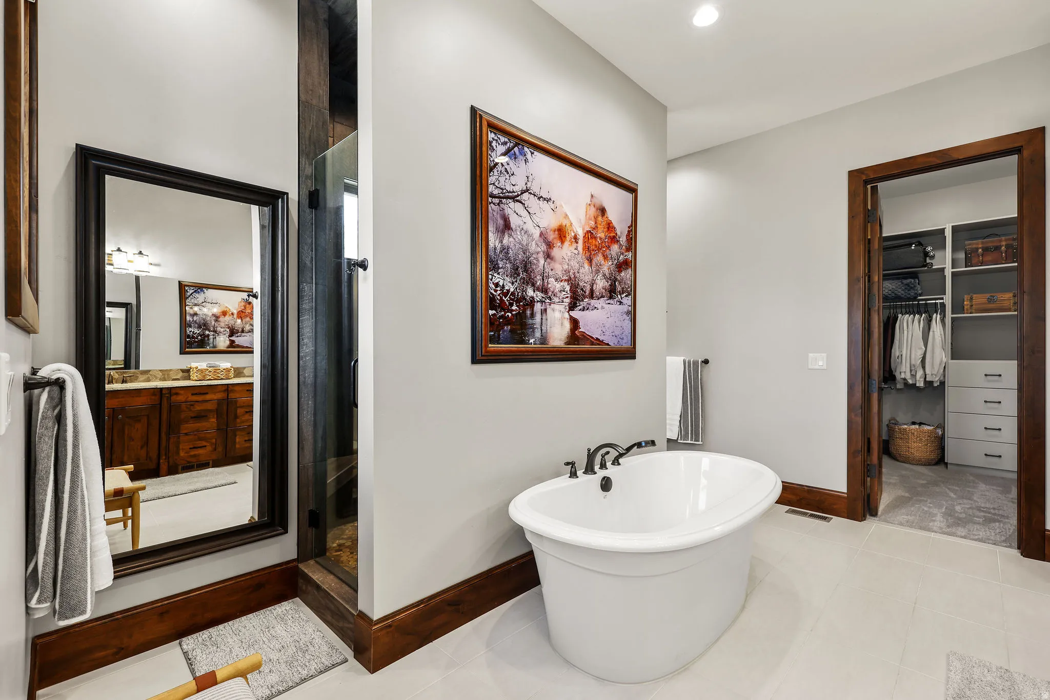 Bathroom featuring a soaking tub, a spacious closet, a shower stall, vanity, and light tile patterned flooring