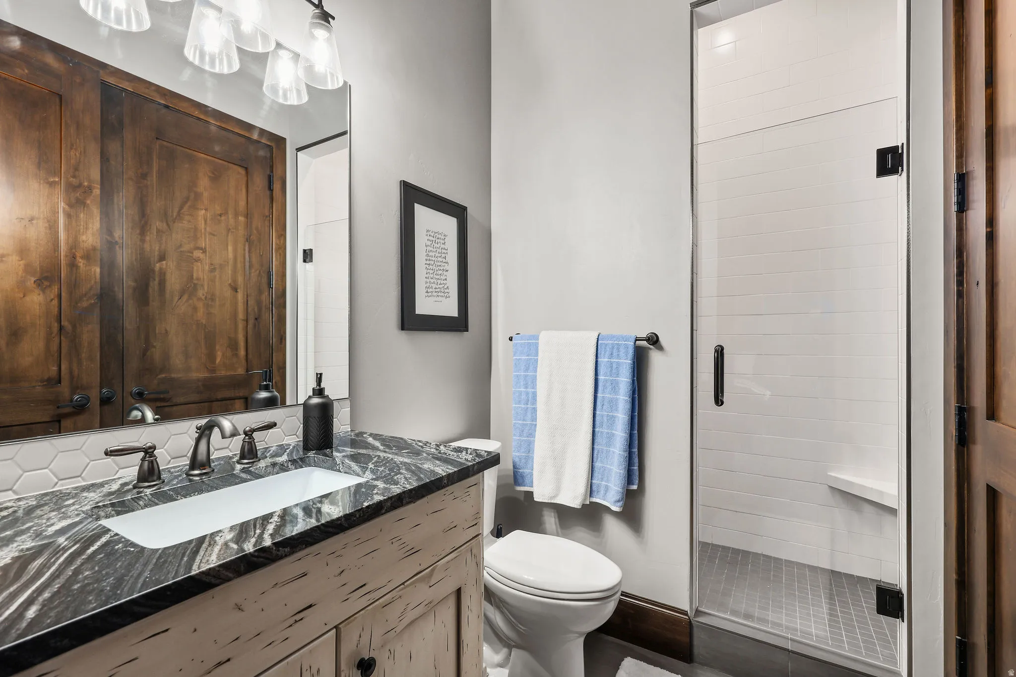 Full bathroom with vanity and a shower stall