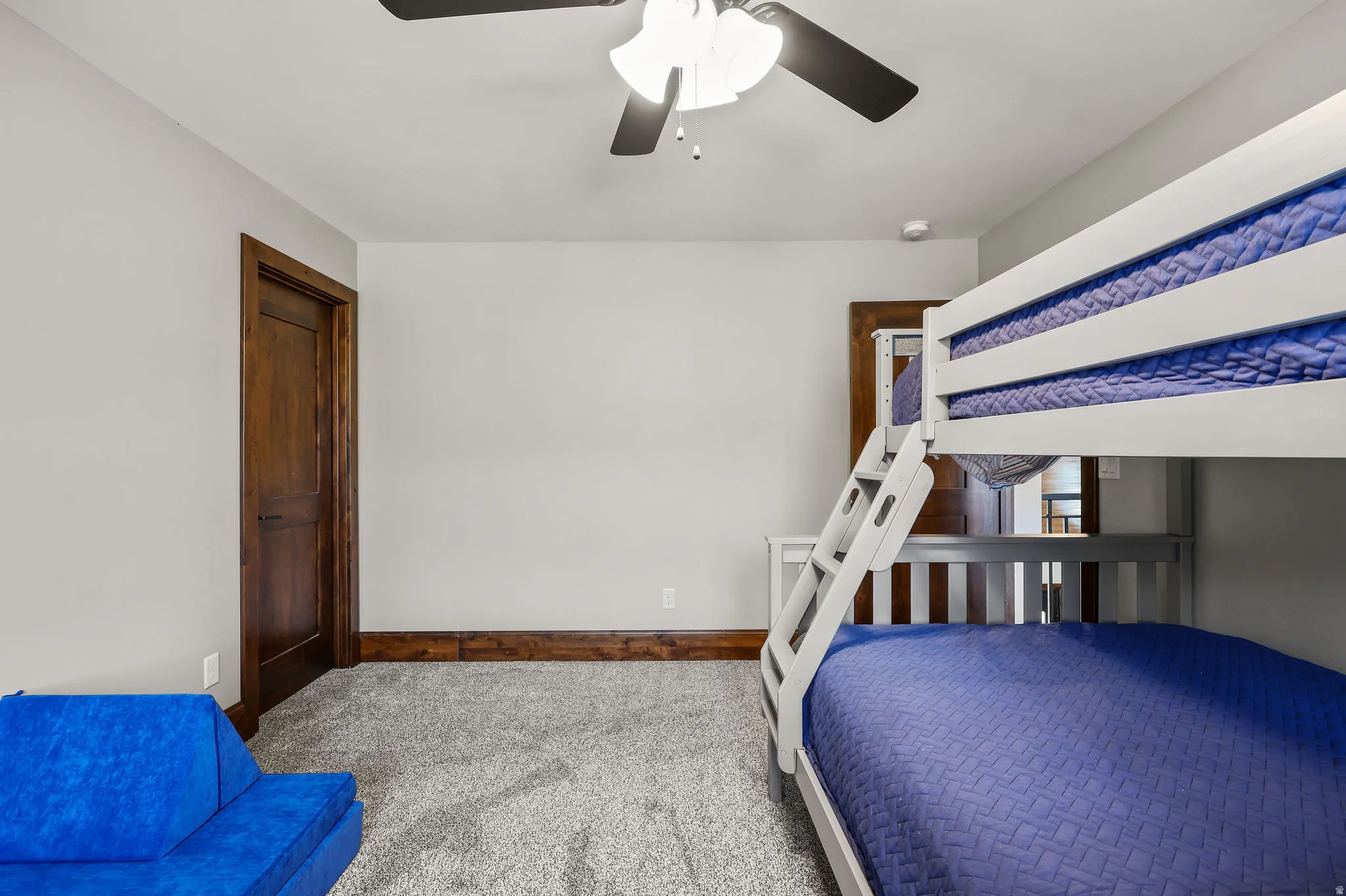 Bedroom with carpet floors and a ceiling fan