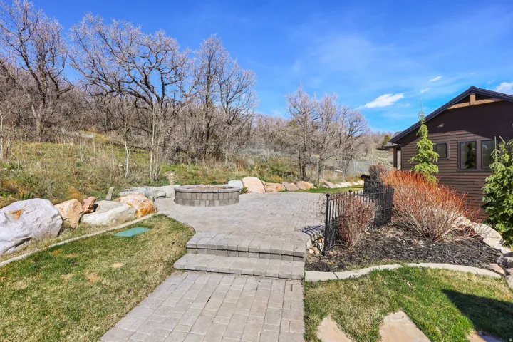 View of yard with an outdoor fire pit and a patio area