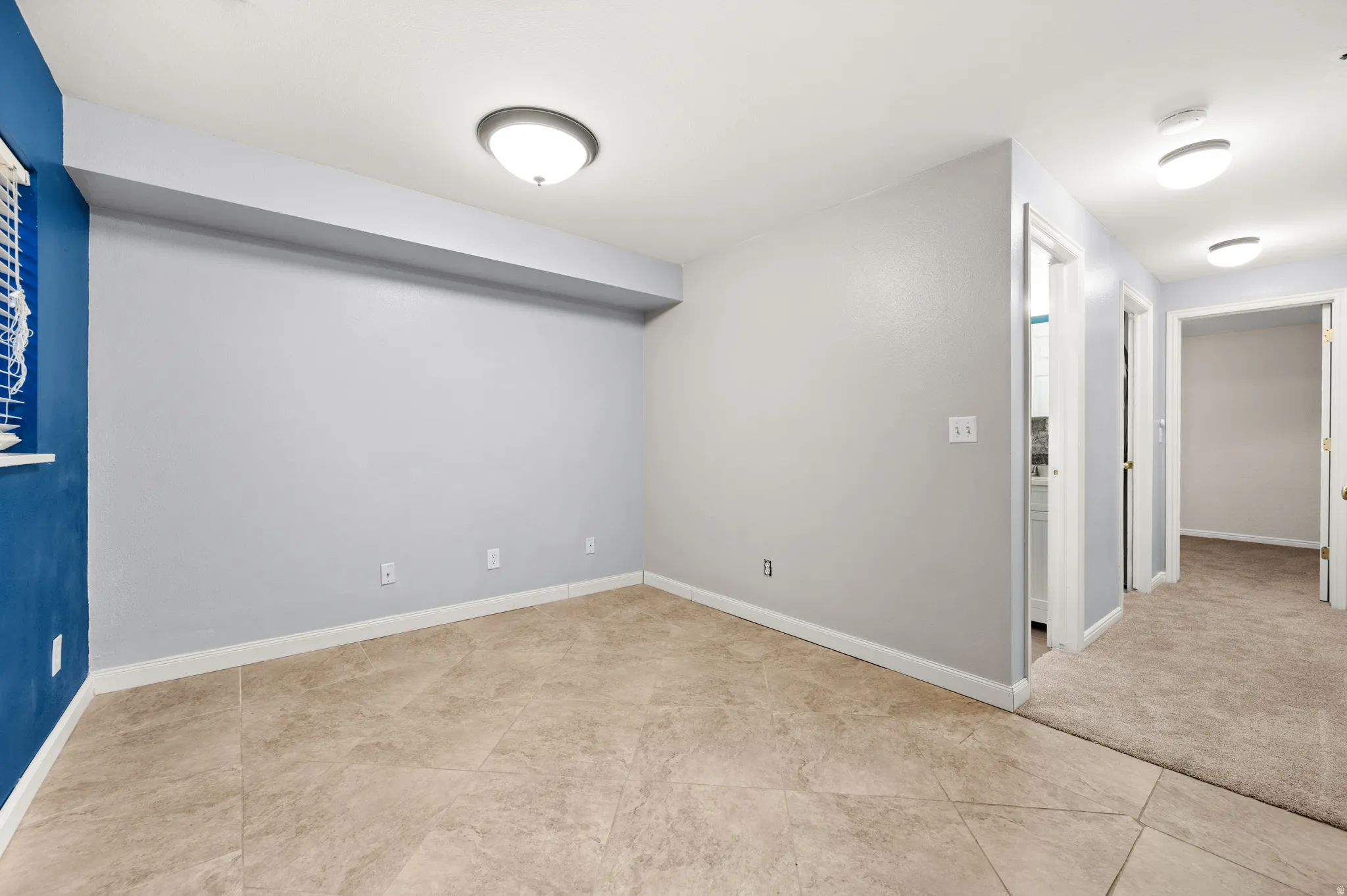 Famliy room loacted in basement with tile floor
