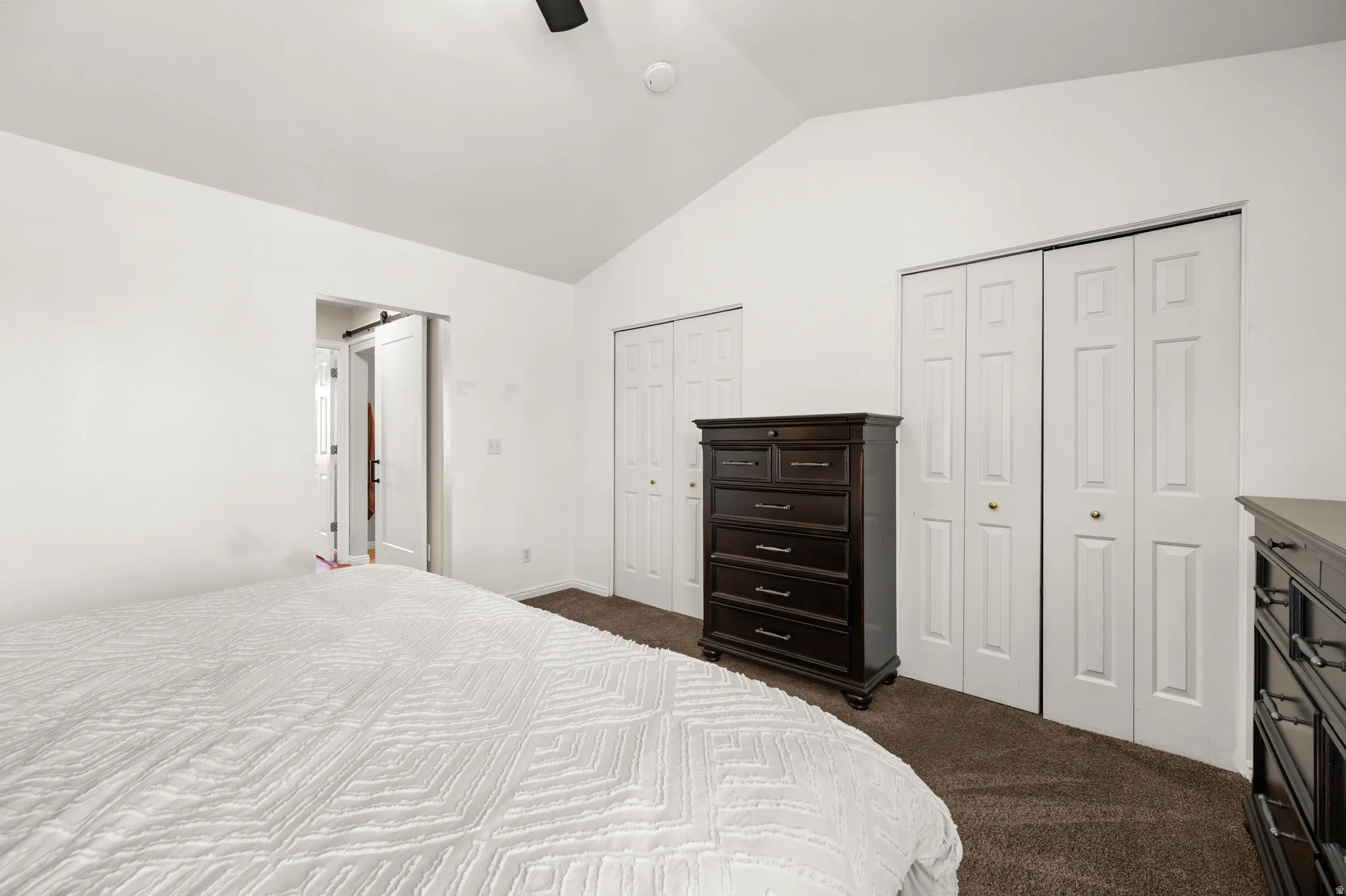 Master bedroom with multiple closets, vaulted celing.