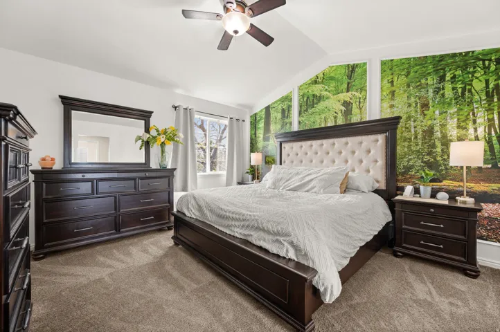 Master Bedroom with vaulted ceiling, ceiling fan, and custom wall mural