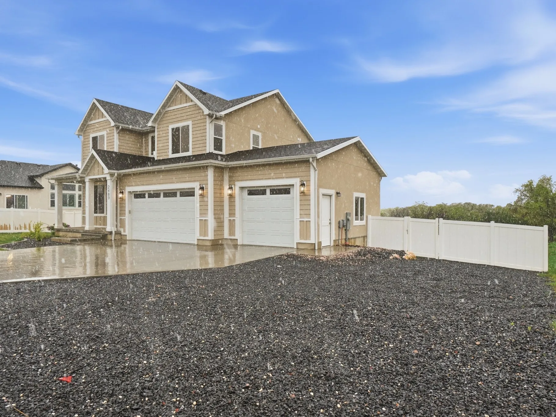 View of front of house with concrete driveway and a garage