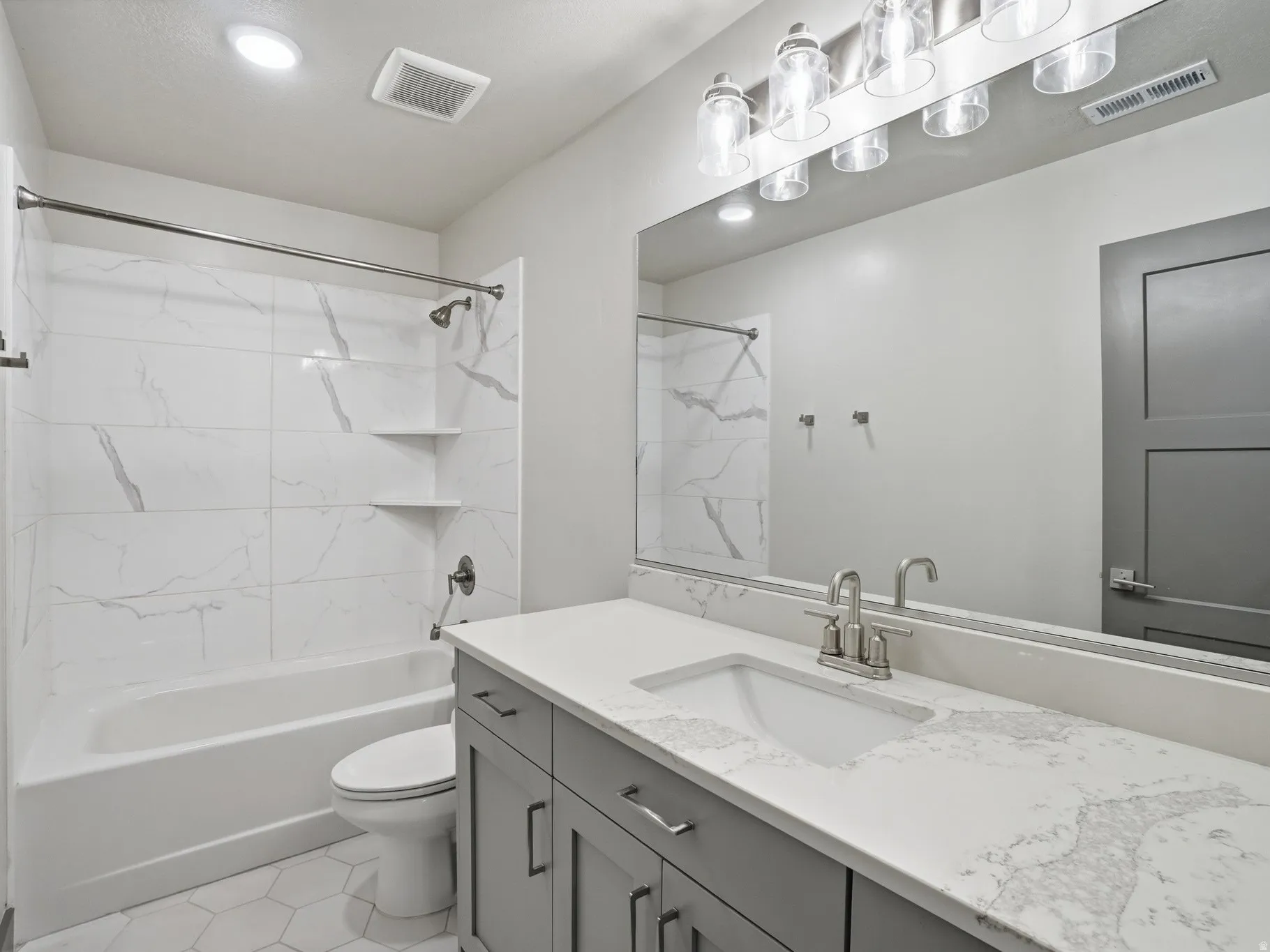 Bathroom featuring vanity and tub / shower combination