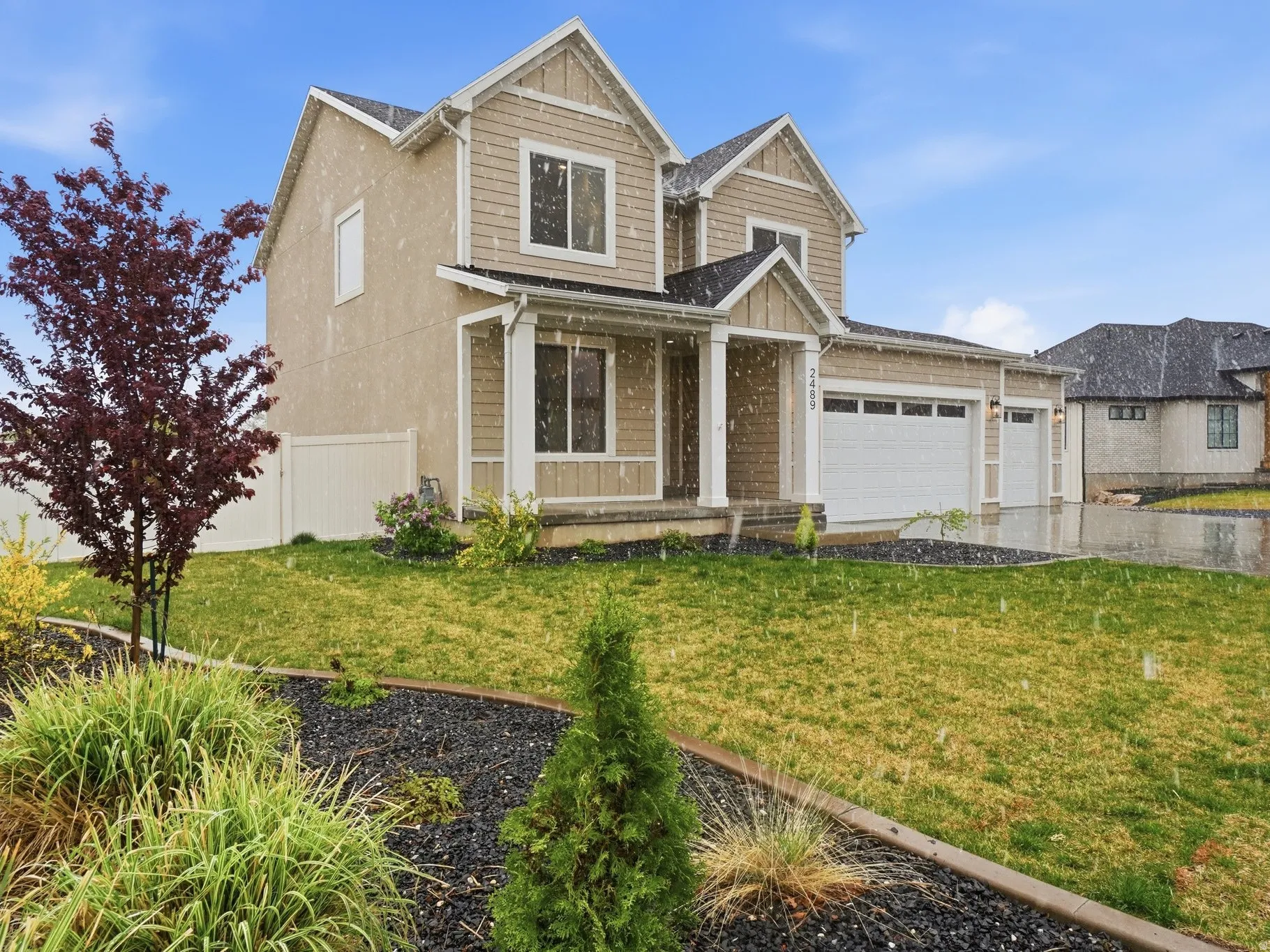 View of front of property featuring an attached garage, covered porch, and driveway