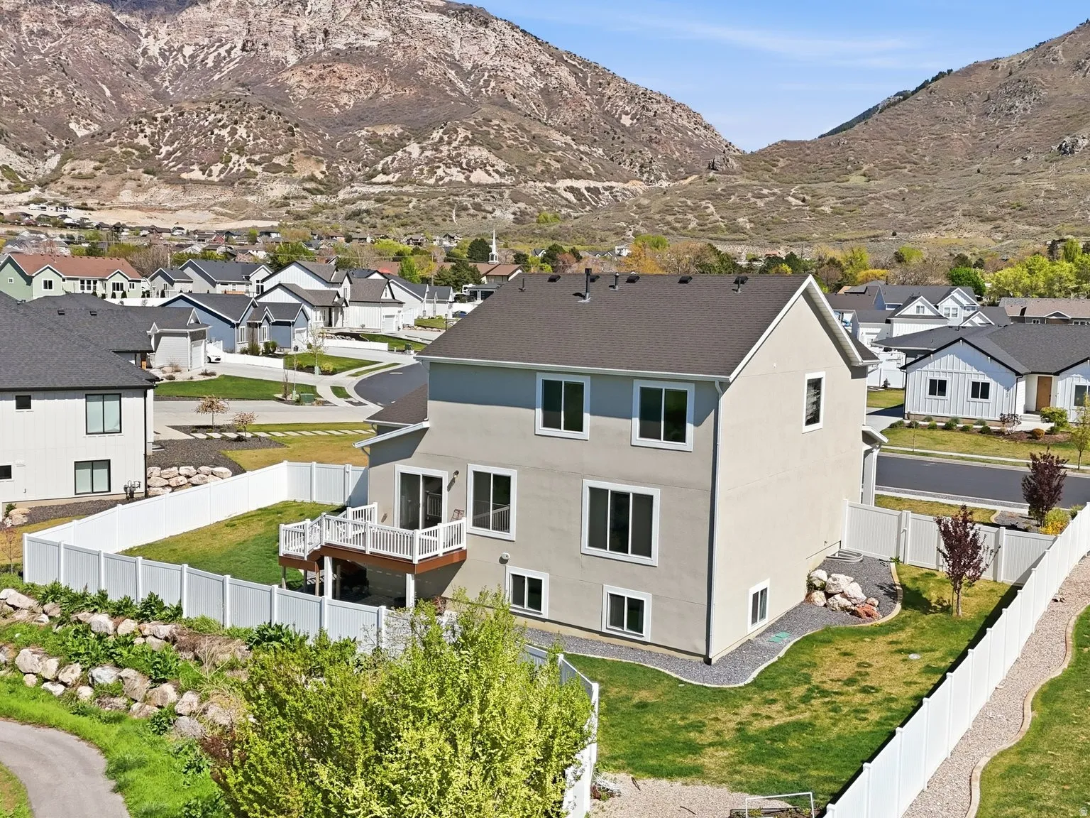 View of mountain backdrop featuring nearby suburban area