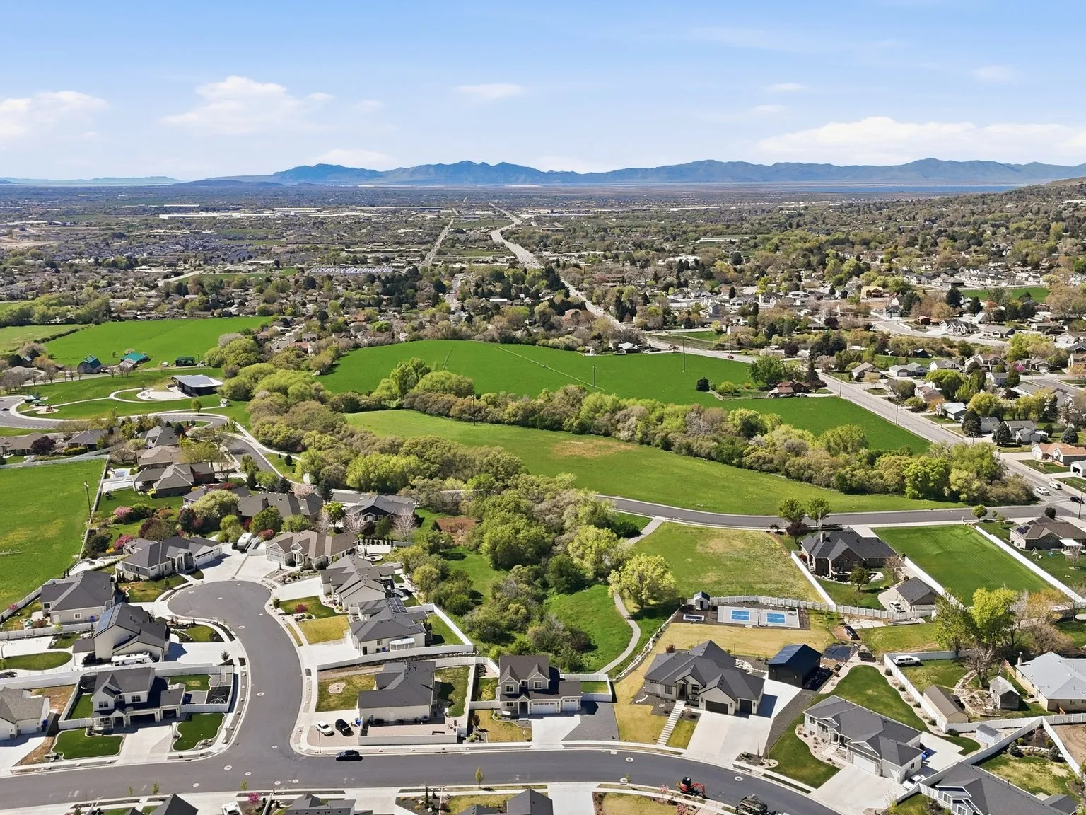 Aerial perspective of suburban area with a mountainous background