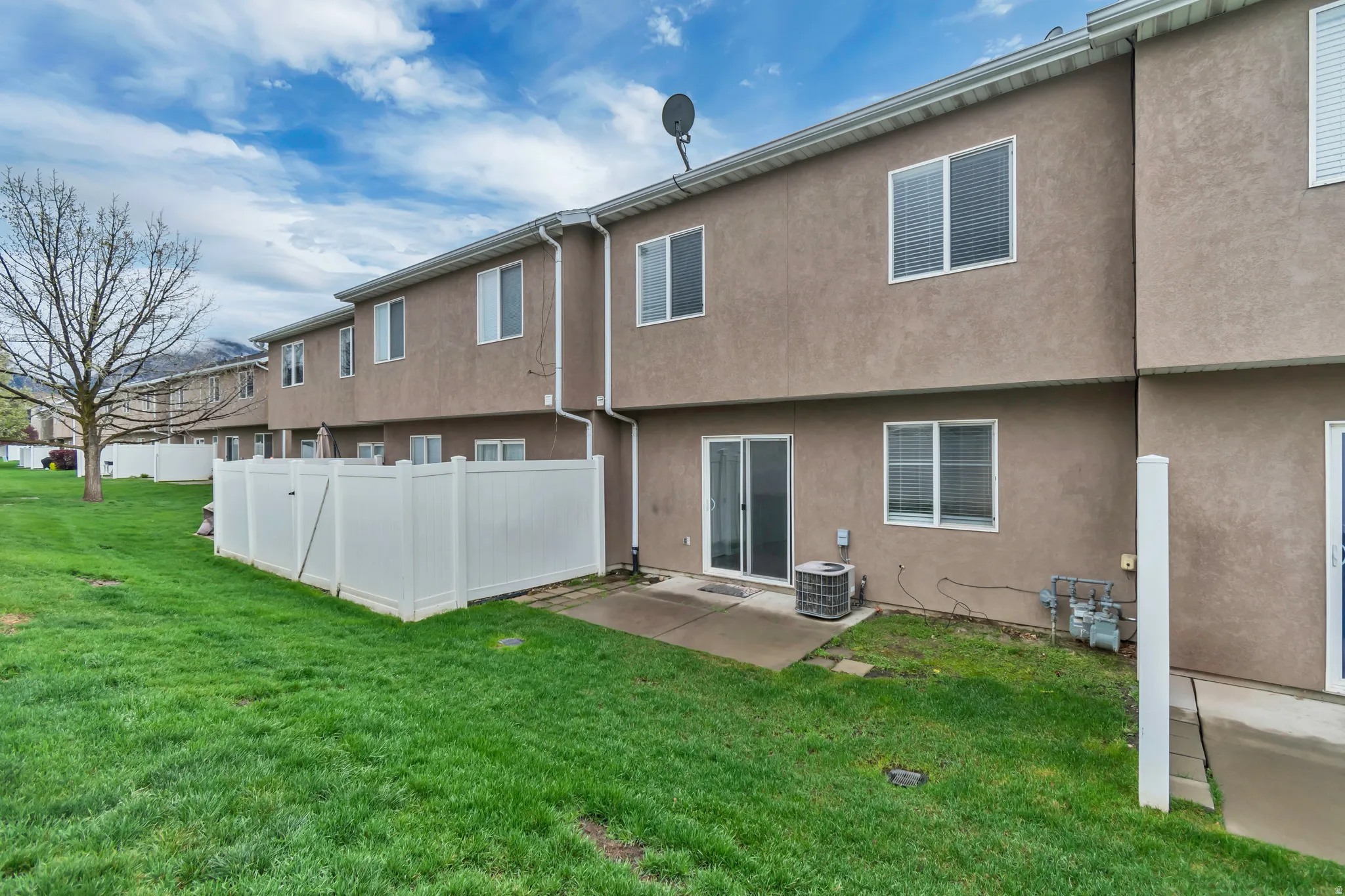 Back of house featuring a patio area and stucco siding