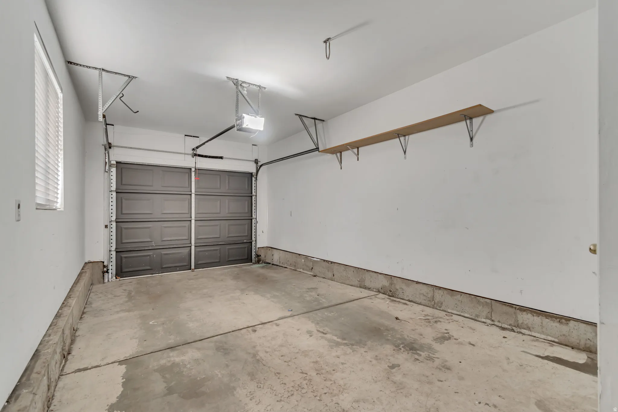 Garage featuring a garage door opener