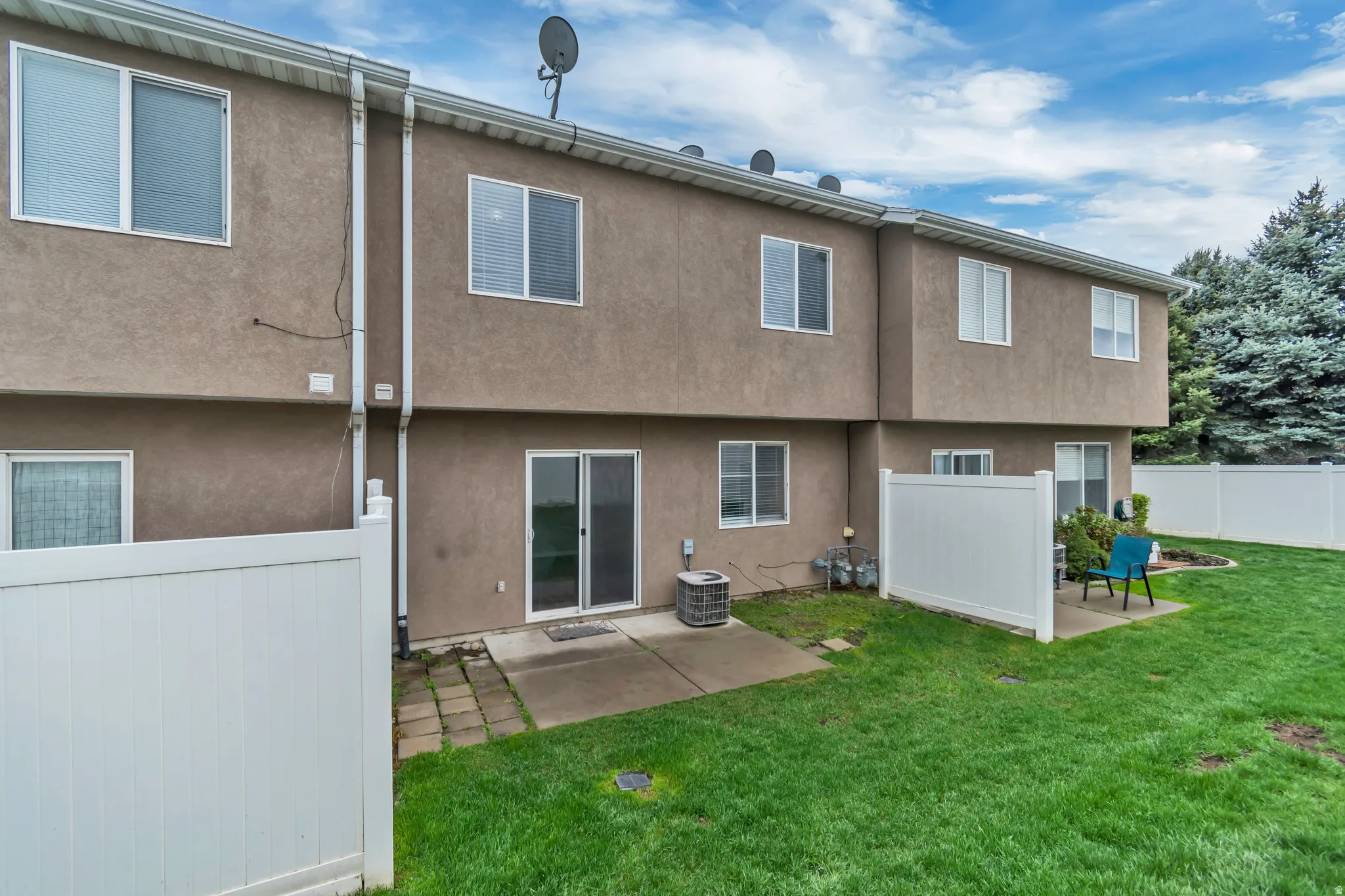 Rear view of property with a patio and stucco siding