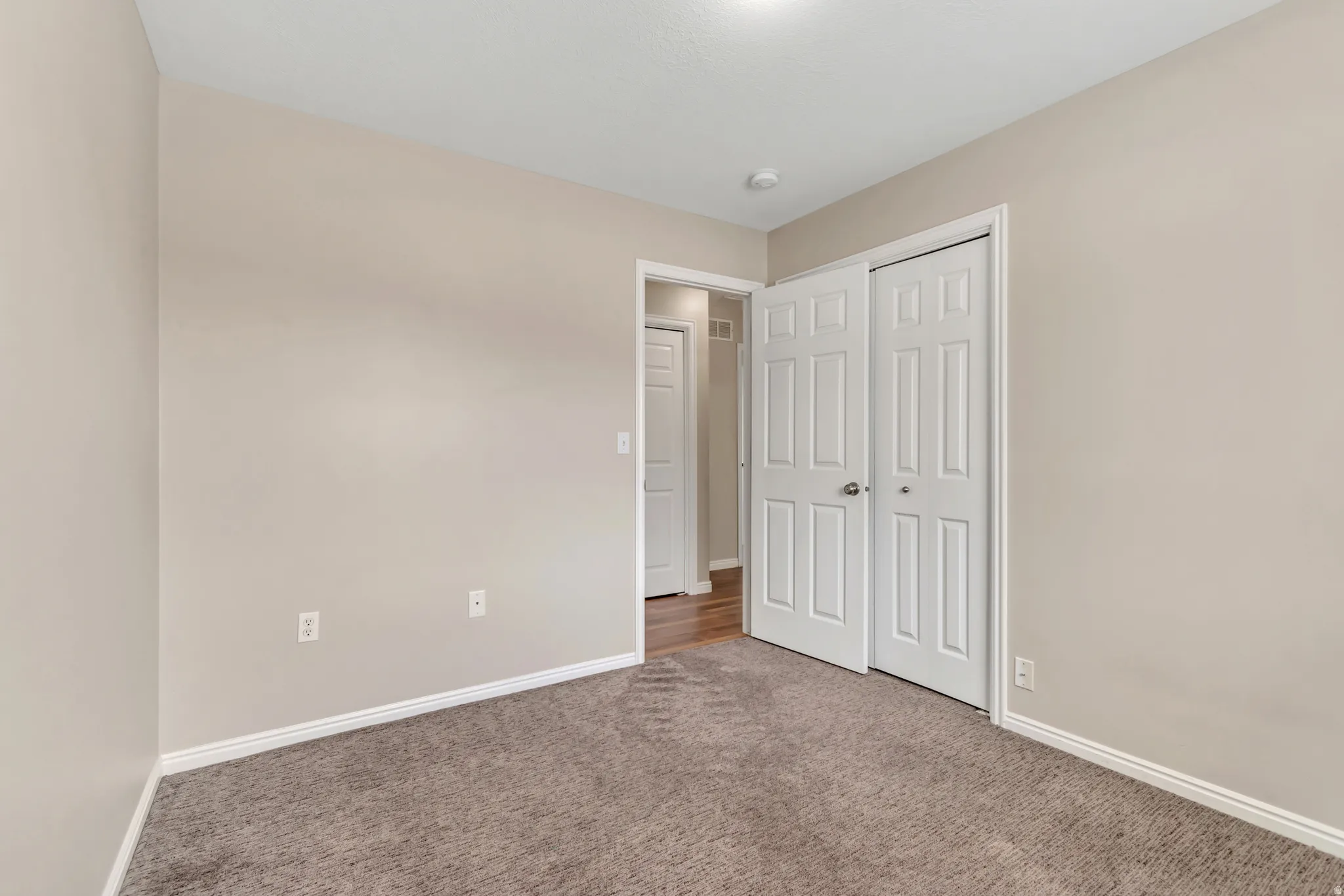 Unfurnished bedroom with carpet and a closet