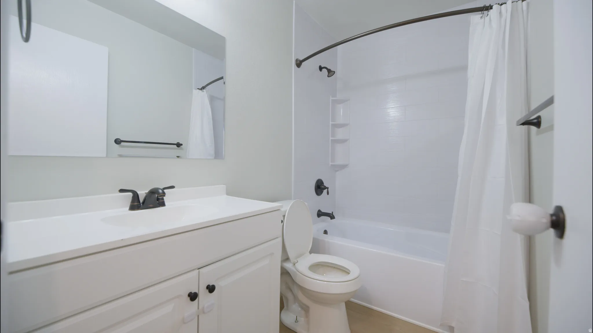 Full bath with vanity and shower / tub combo with curtain