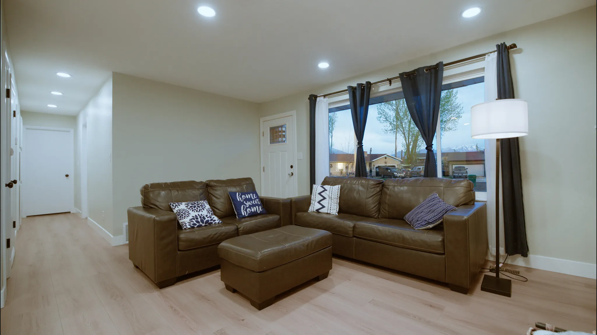 Living area featuring light wood-style flooring and recessed lighting