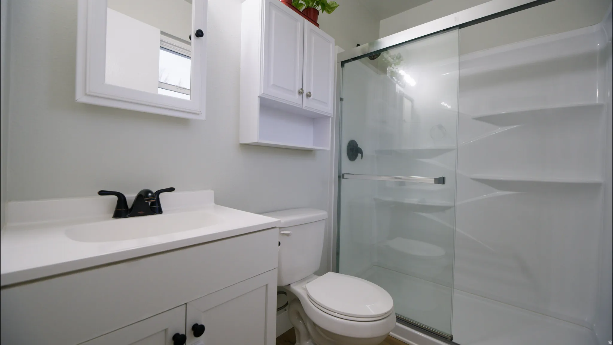 Bathroom with vanity and a stall shower