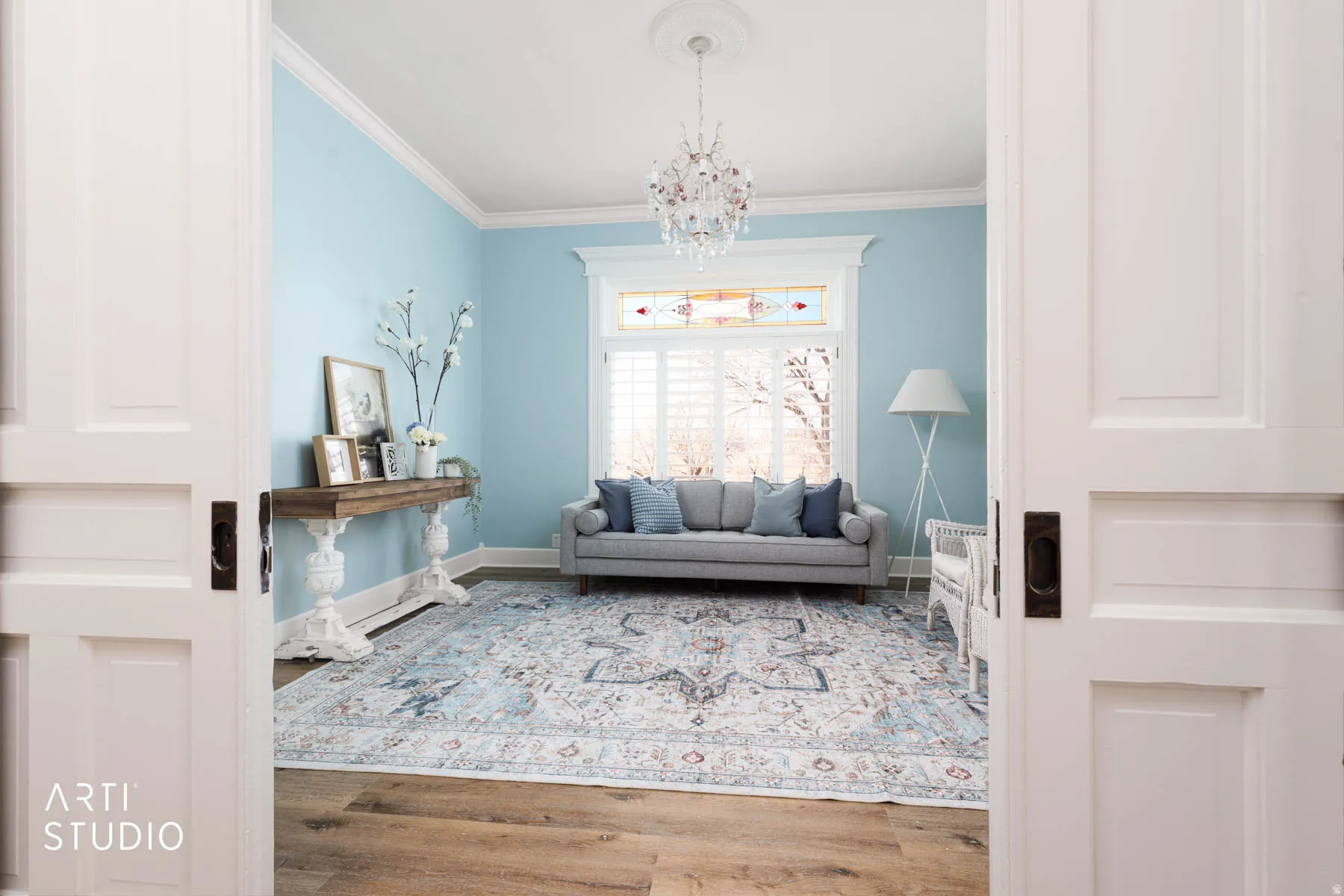 Living room (the Parlour)  with ornamental molding, crystal chandelier.