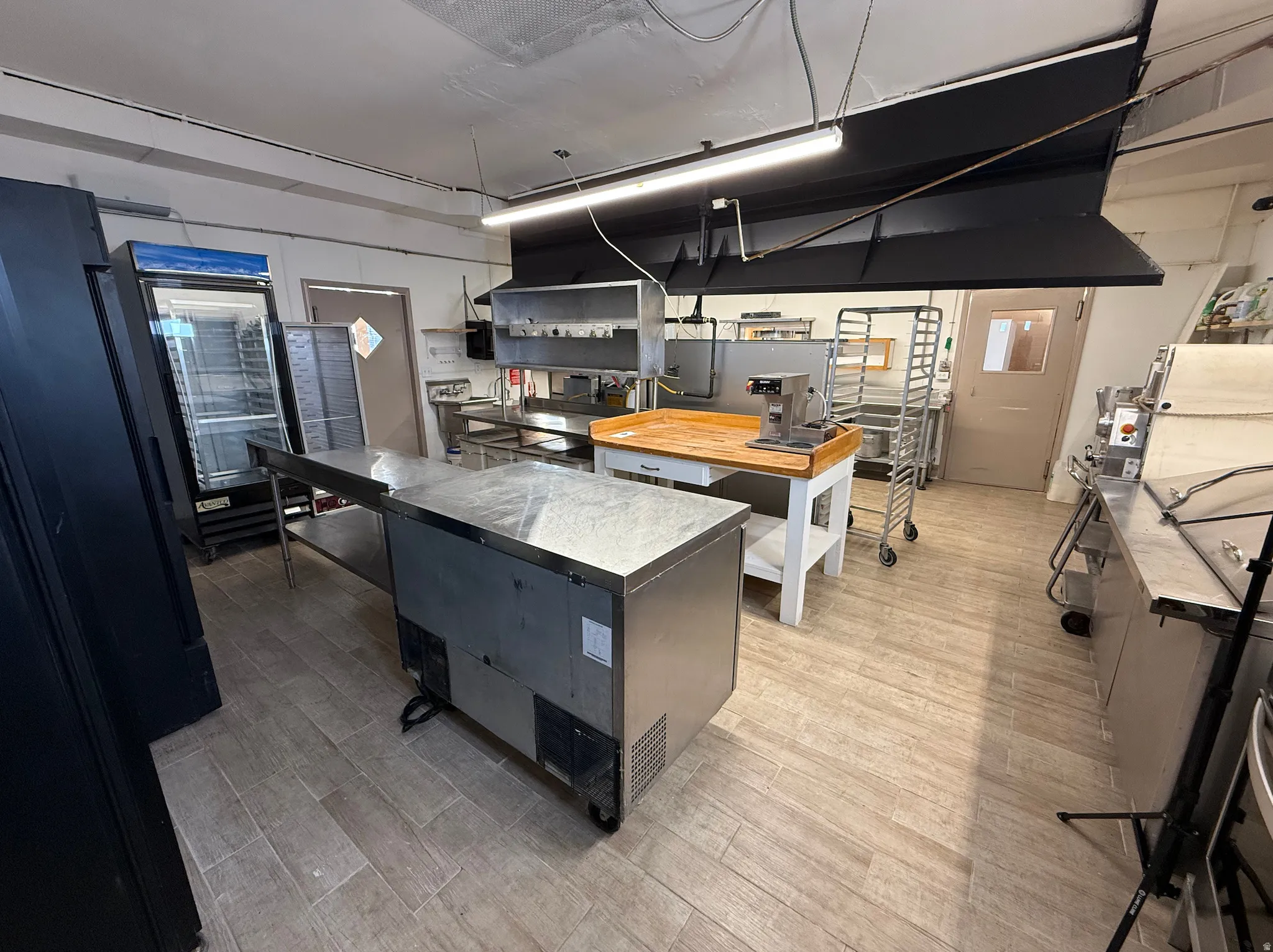 Kitchen featuring a kitchen island, freestanding refrigerator, and dark cabinets