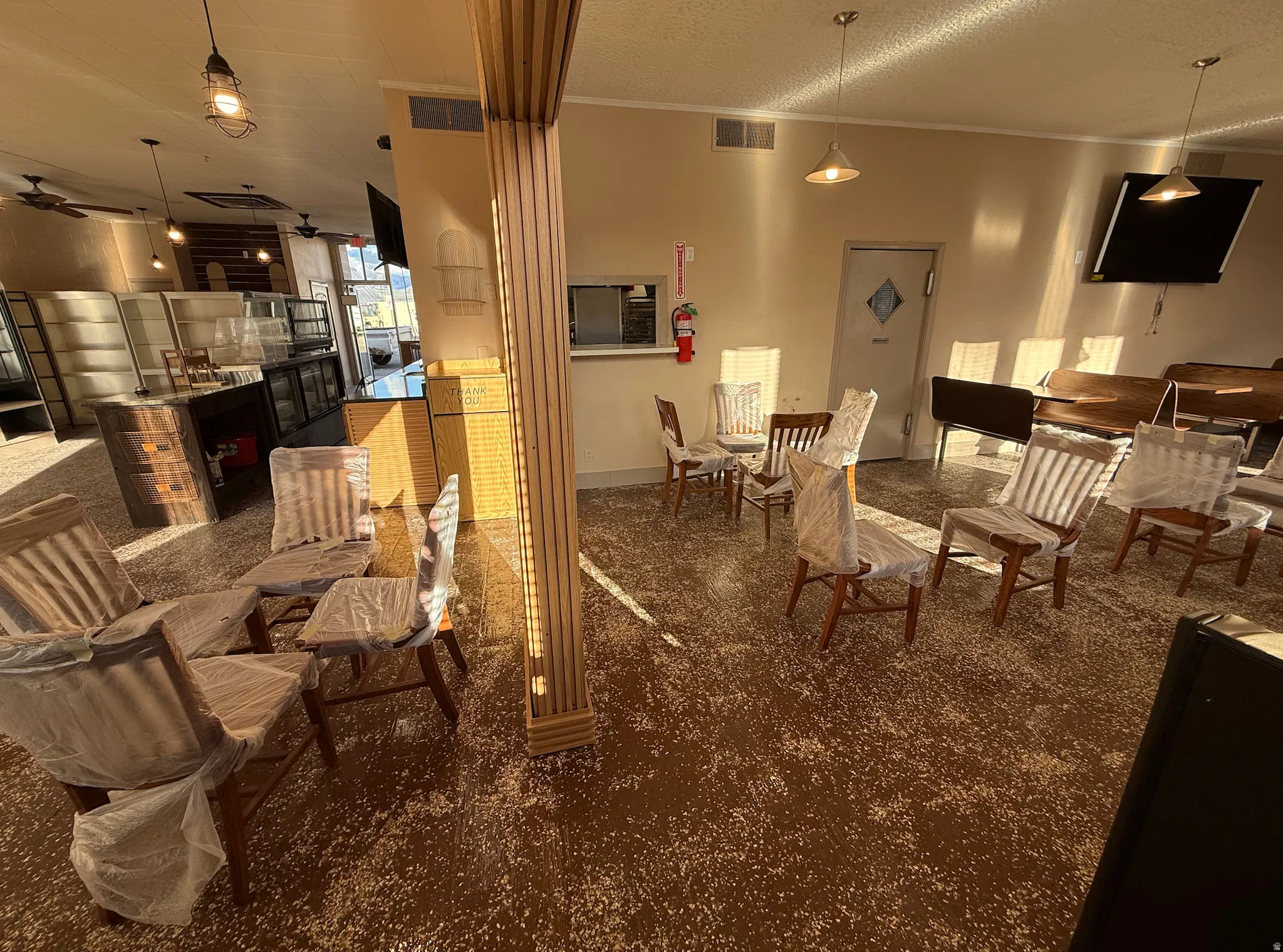 Dining space featuring crown molding, ceiling fan, and a textured ceiling