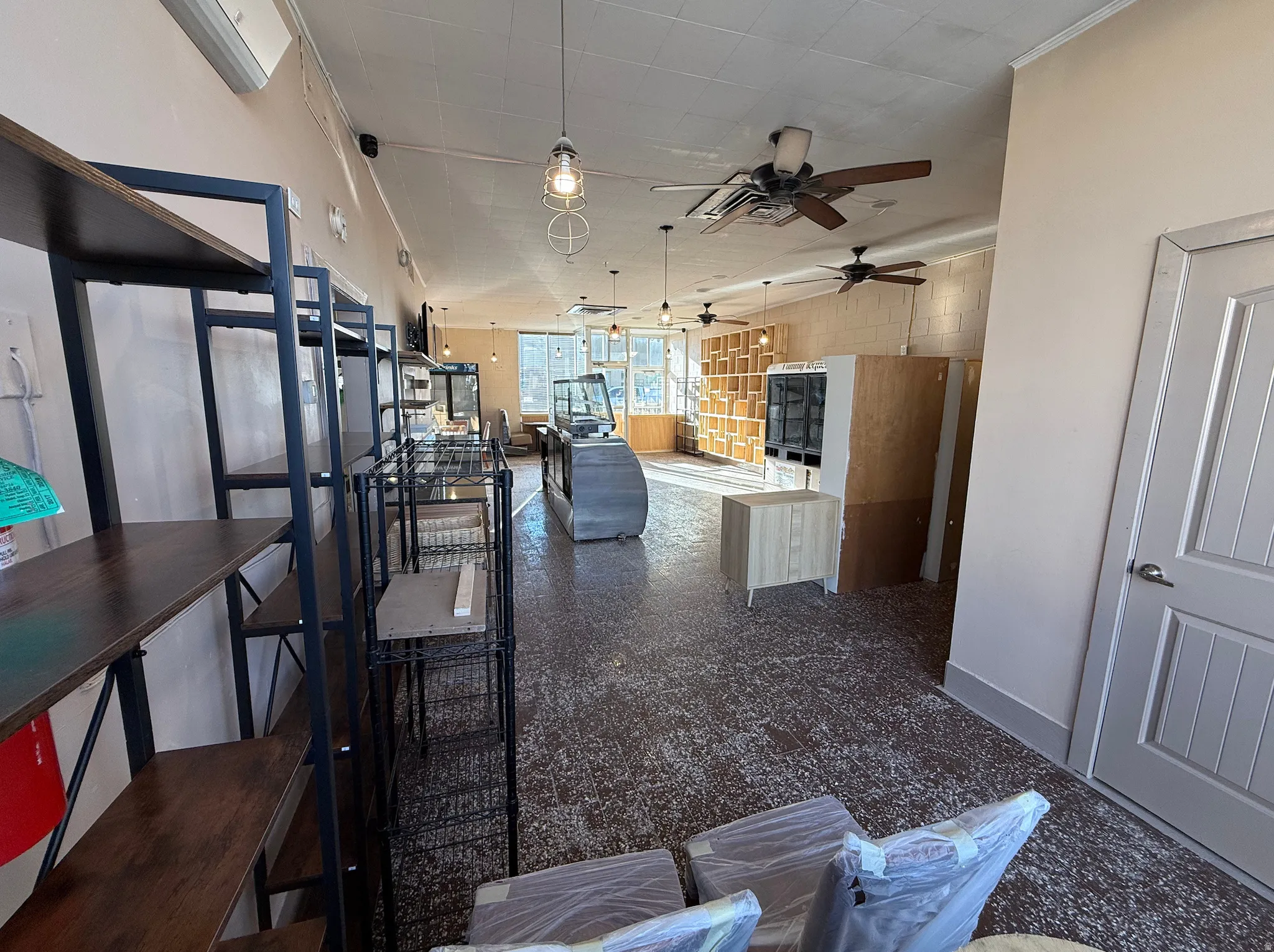 Kitchen with a ceiling fan, open floor plan, and pendant lighting