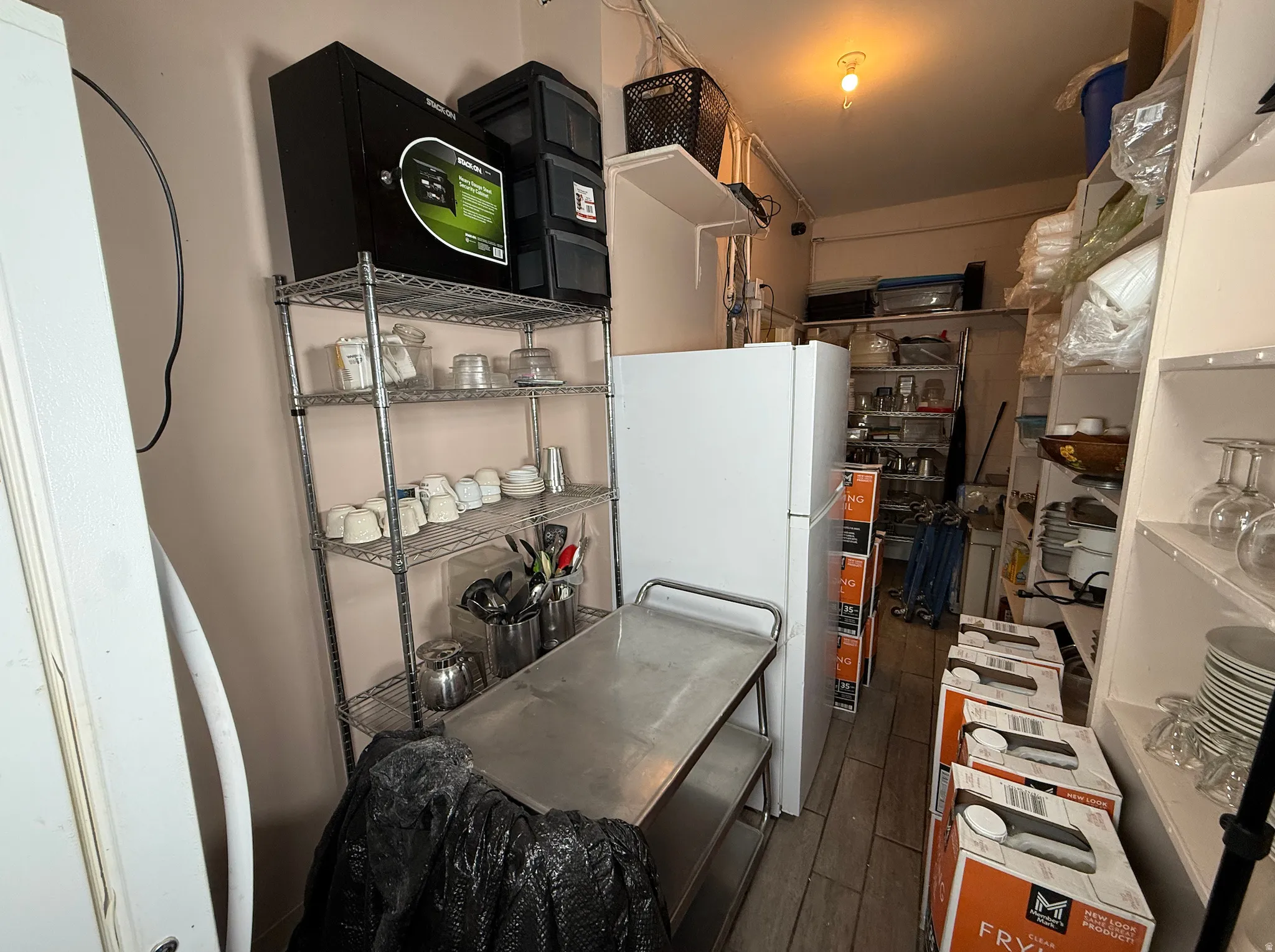 Kitchen featuring freestanding refrigerator and dark wood finished floors