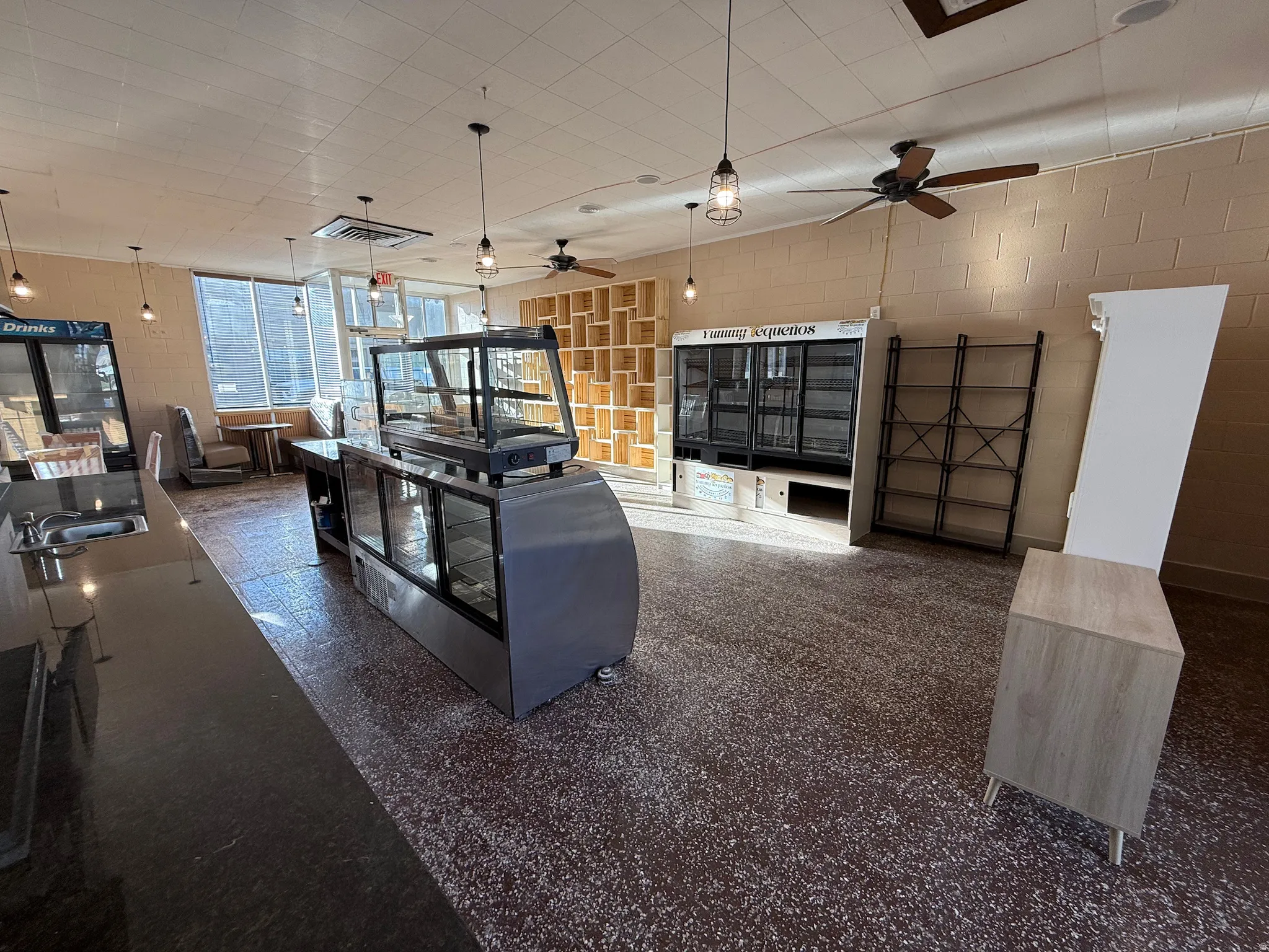 Living area with concrete block wall and ceiling fan