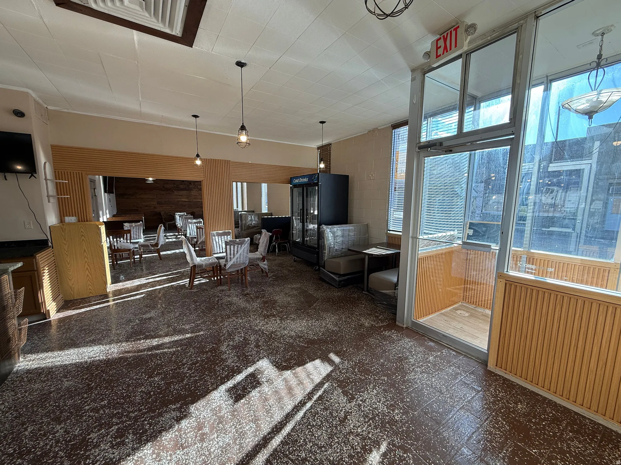 Living area with wood walls and dark floors