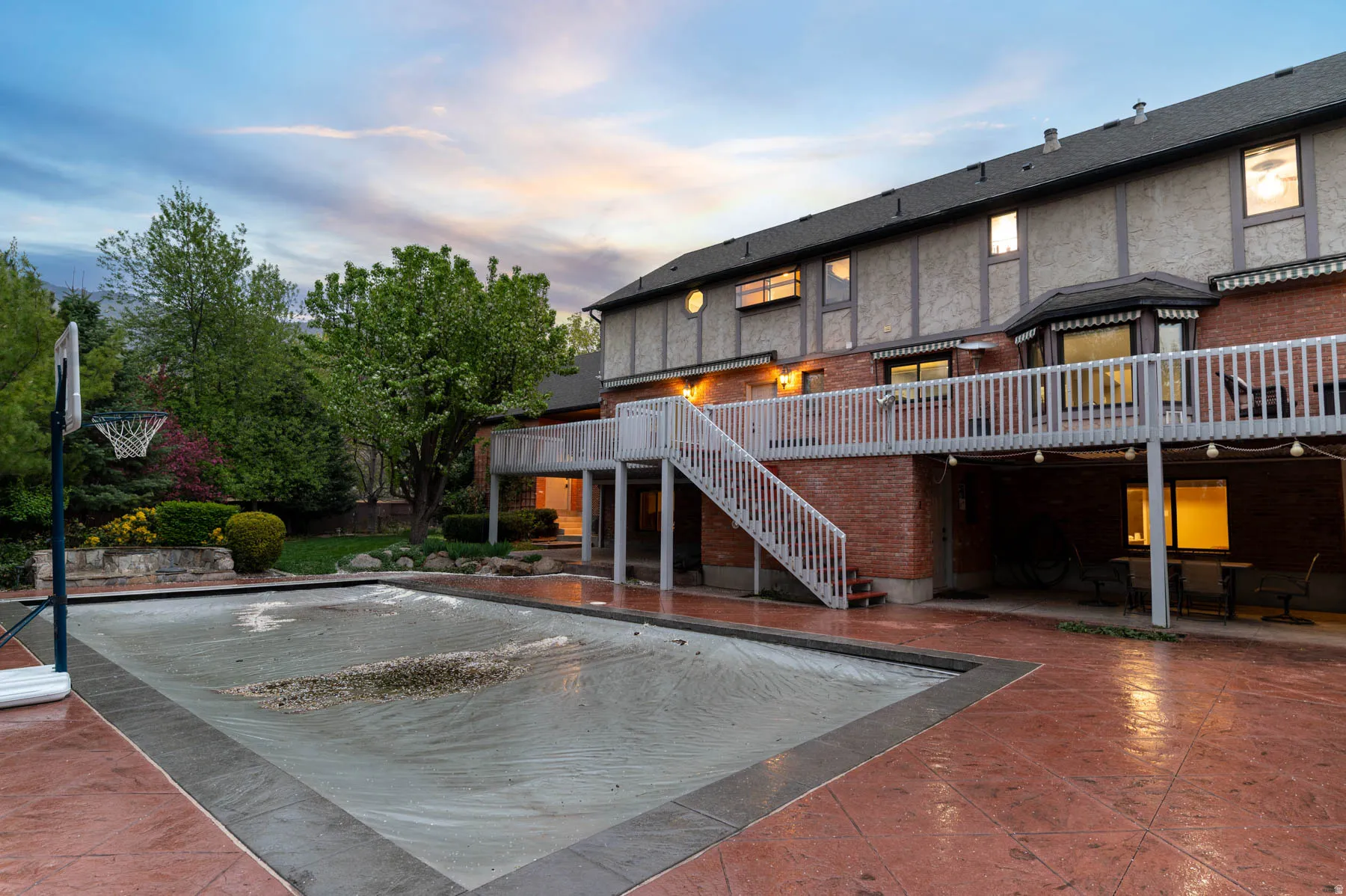 Exterior space with a patio, brick siding, and a deck