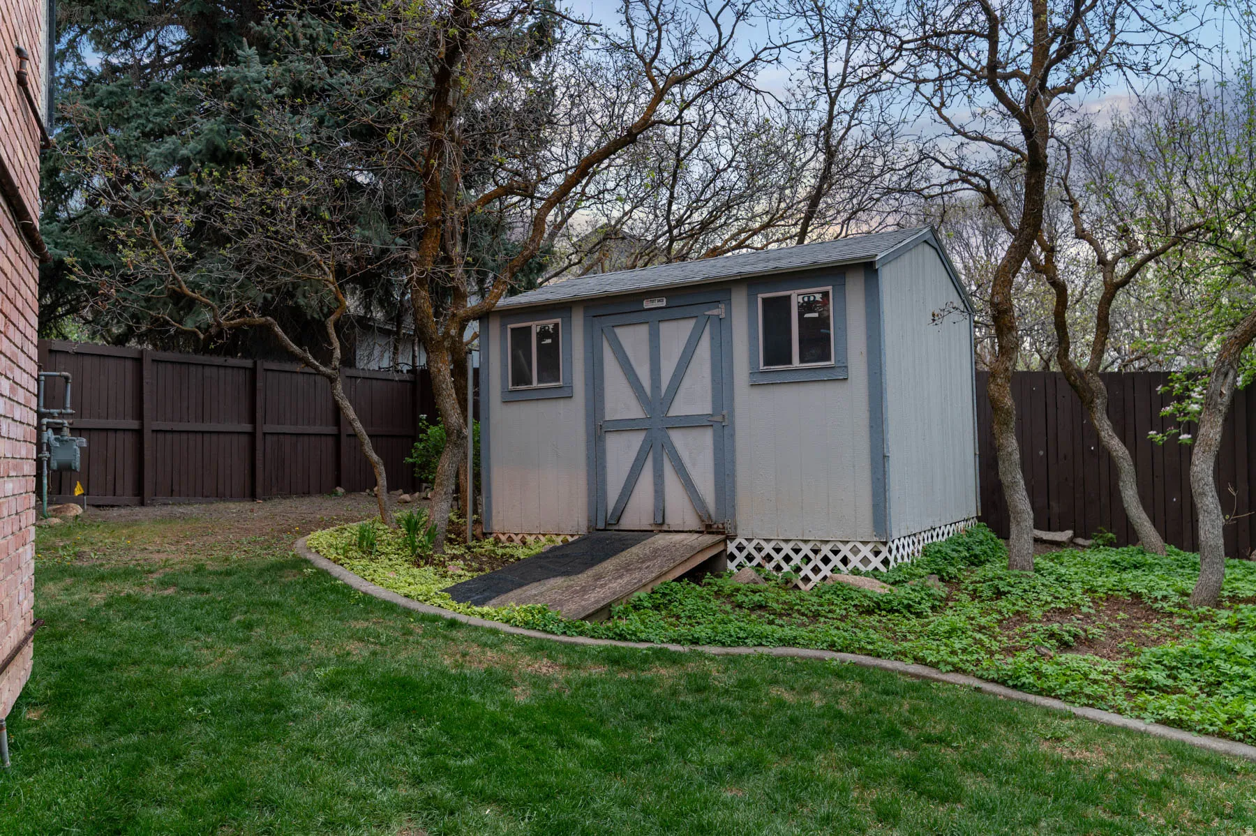 View of shed with a fenced backyard