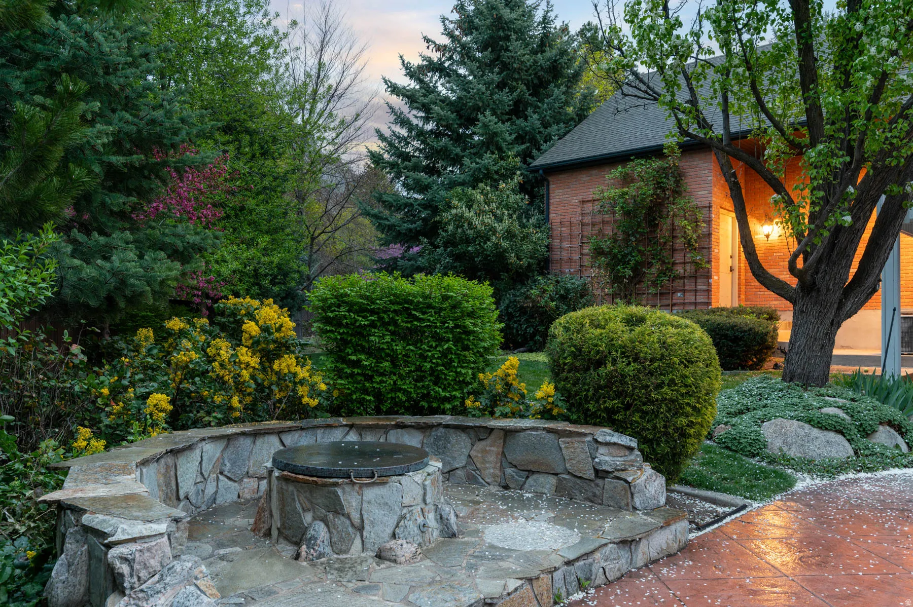 Patio terrace at dusk with an outdoor fire pit and a patio area