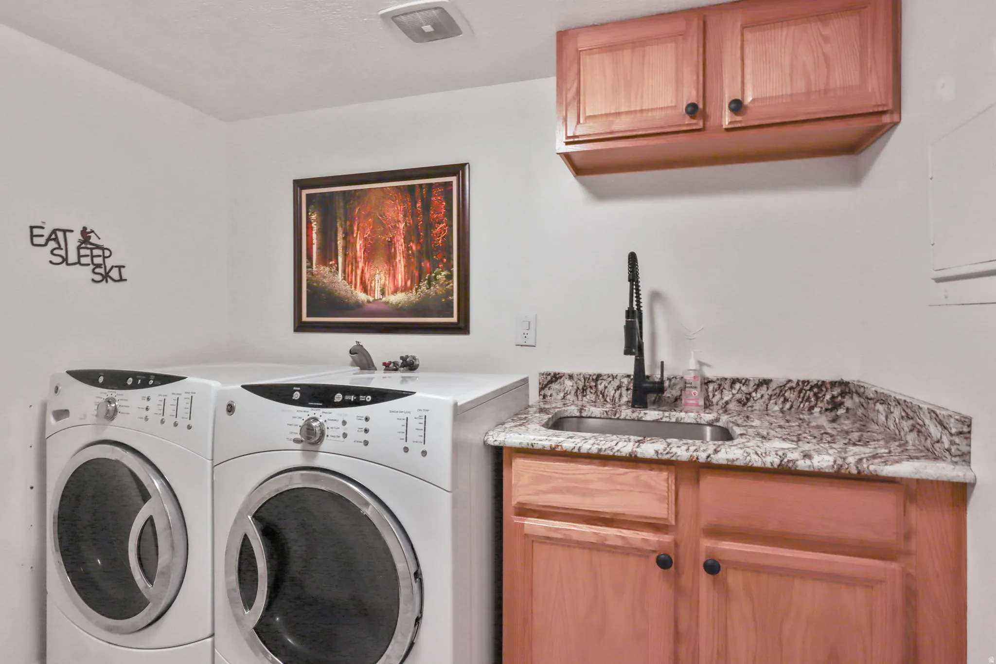 Laundry room with washer and dryer and cabinet space