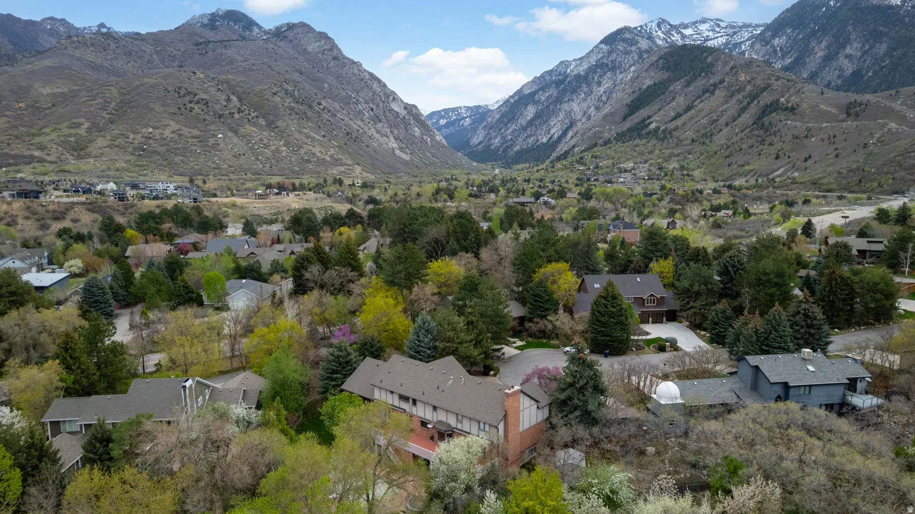 Aerial perspective of suburban area with a mountainous background