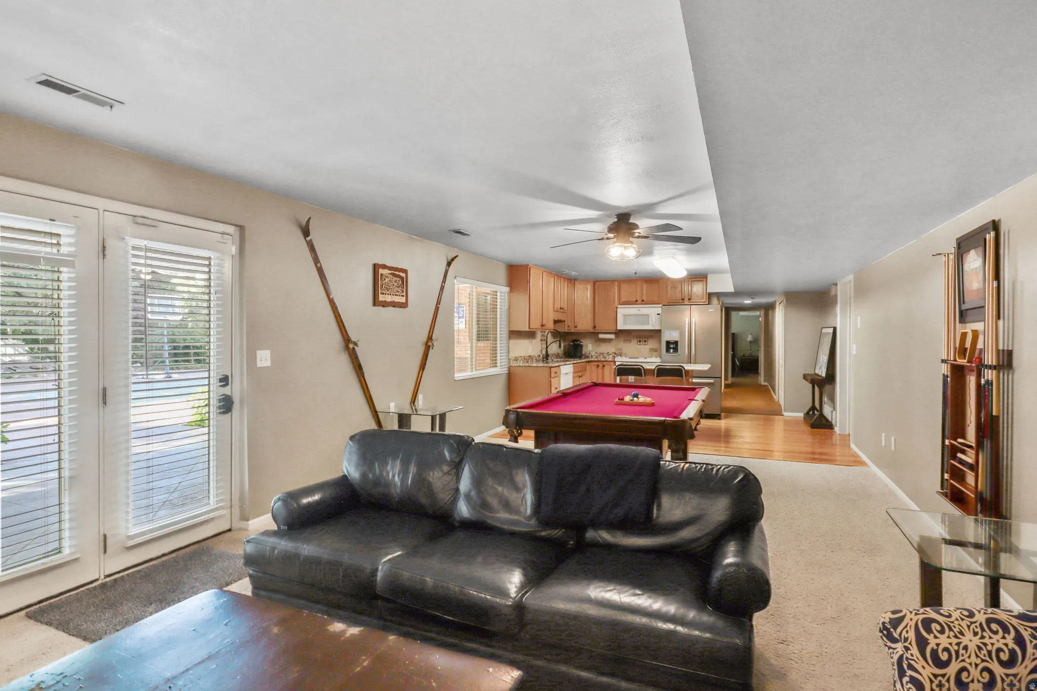 Playroom with a ceiling fan, billiards table, and light carpet