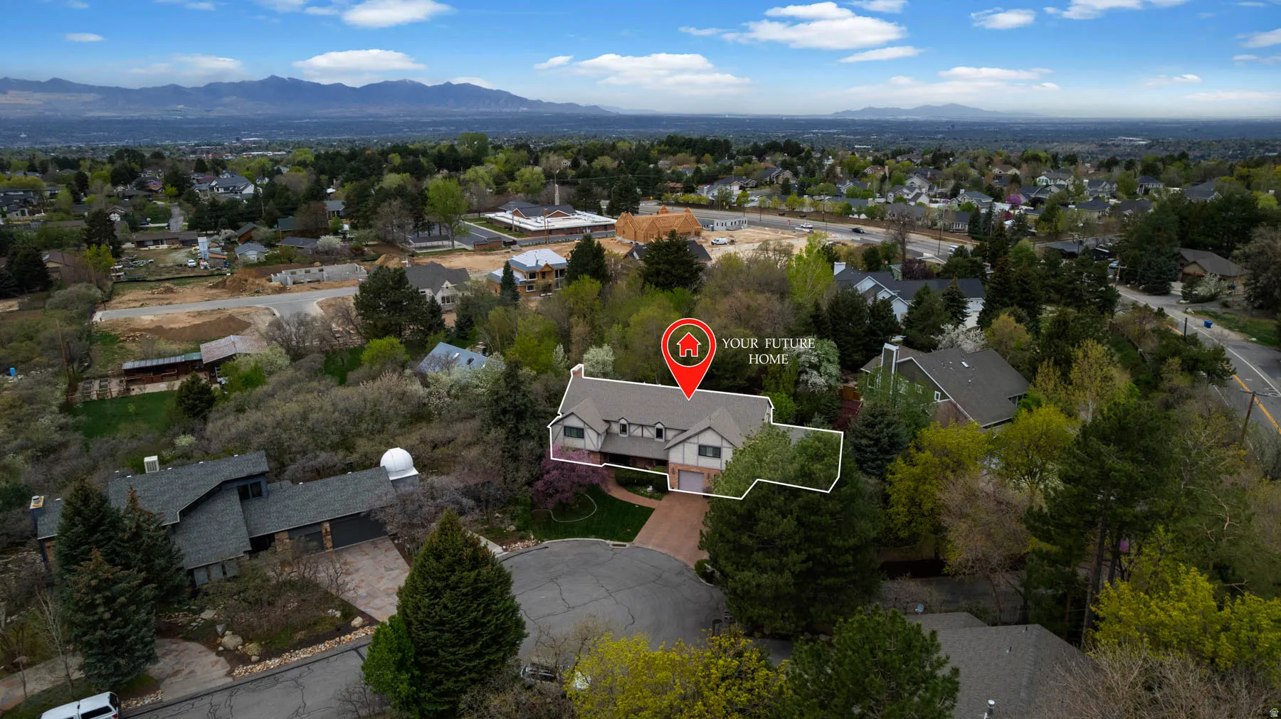 Aerial perspective of suburban area featuring a mountain backdrop and property boundaries highlighted