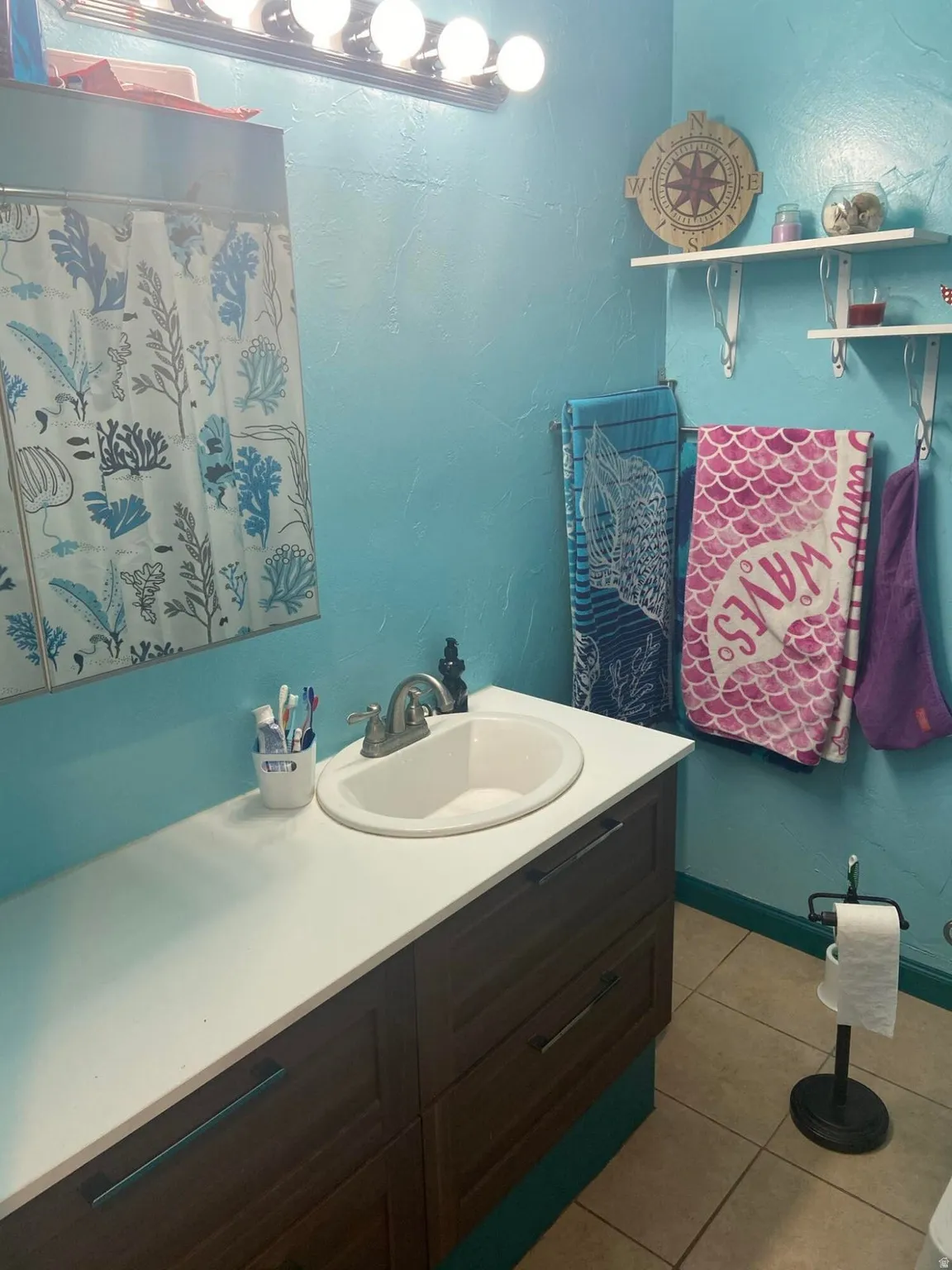 Bathroom featuring vanity and light tile patterned floors