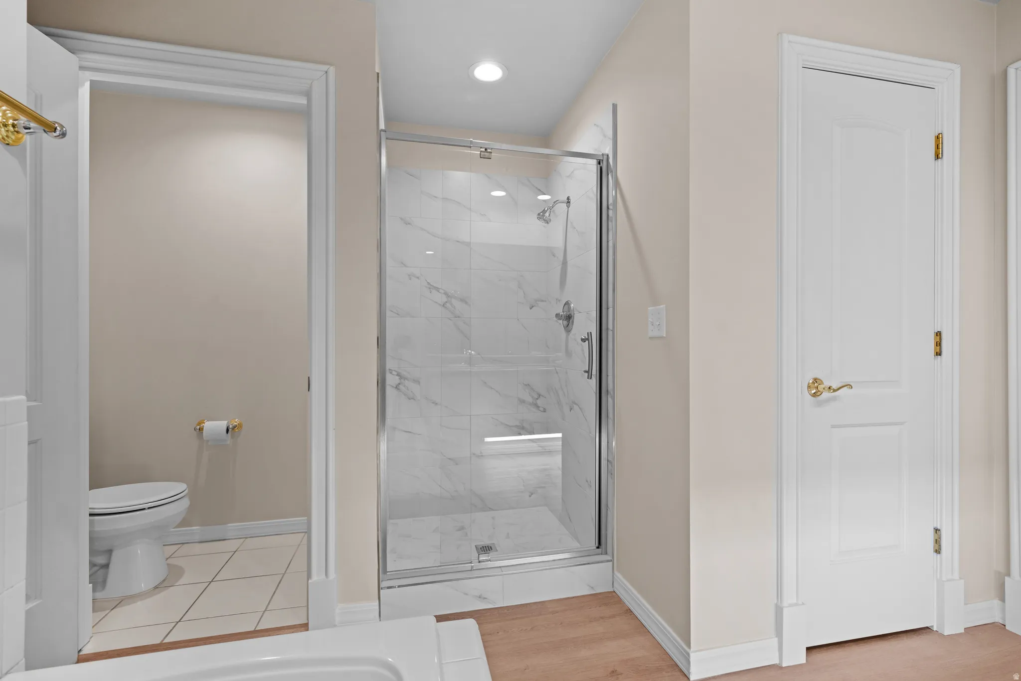 Bathroom featuring a marble finish shower and recessed lighting