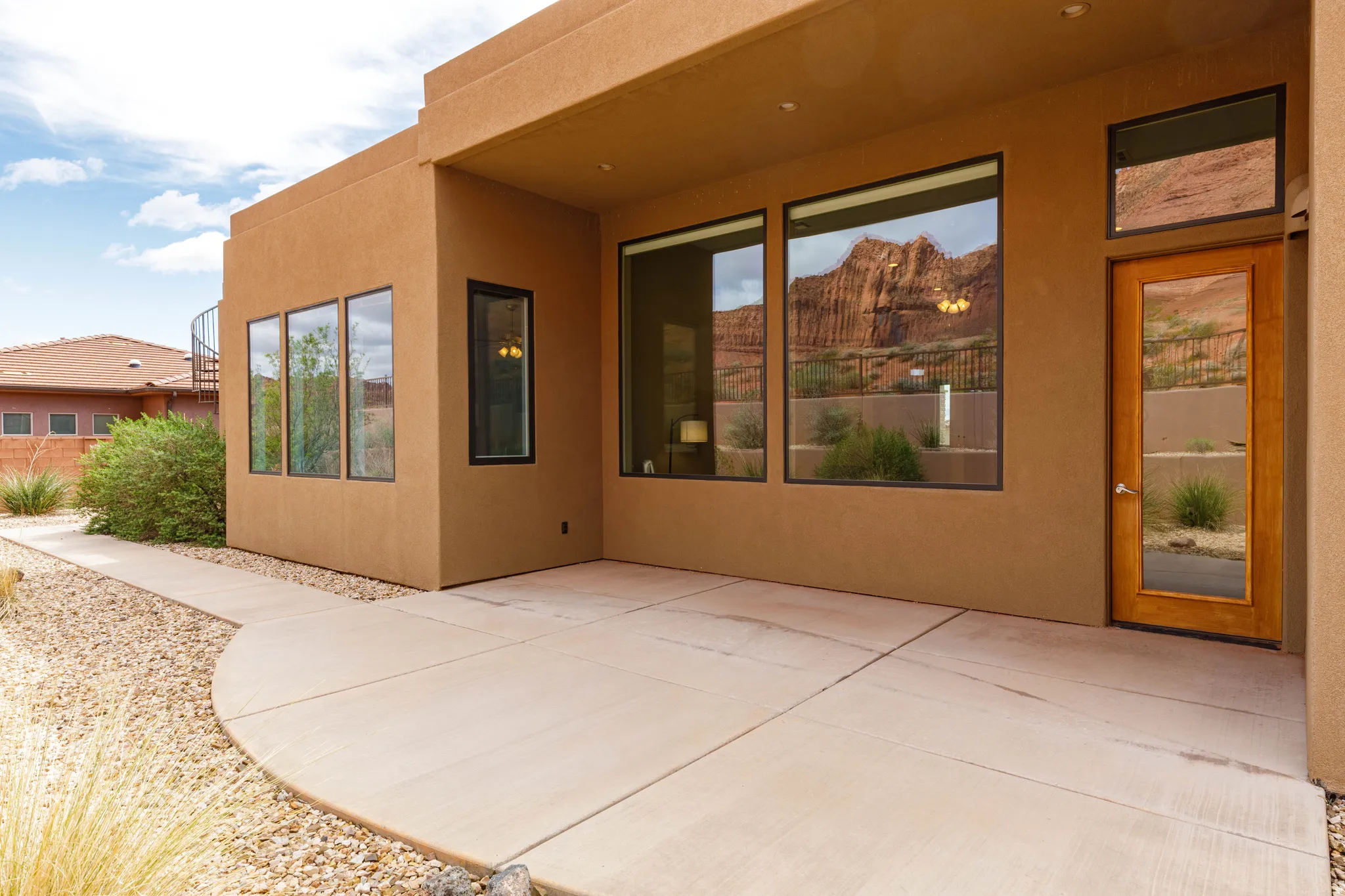 Property entrance featuring a patio and stucco siding