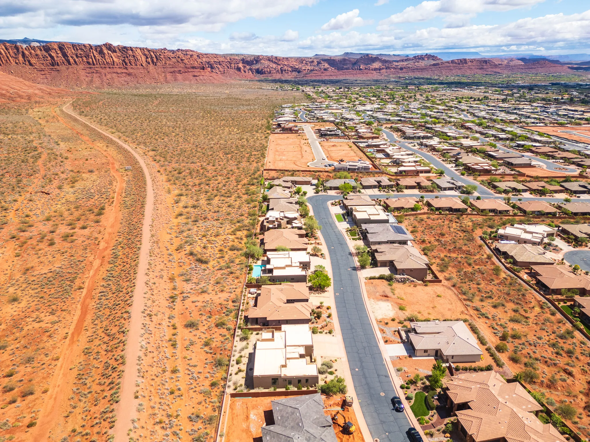 Aerial view of residential area featuring a mountainous background