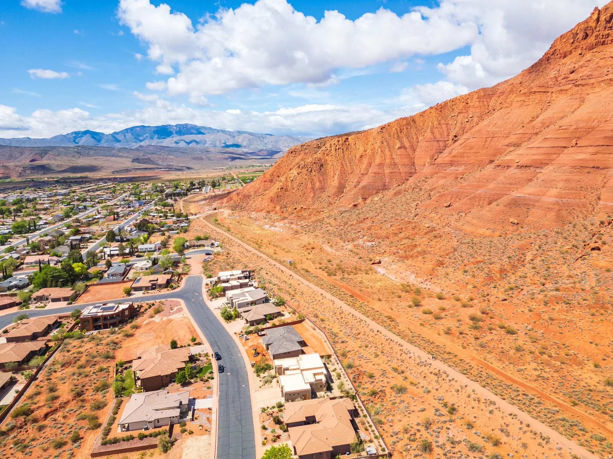Aerial perspective of suburban area with a mountainous background